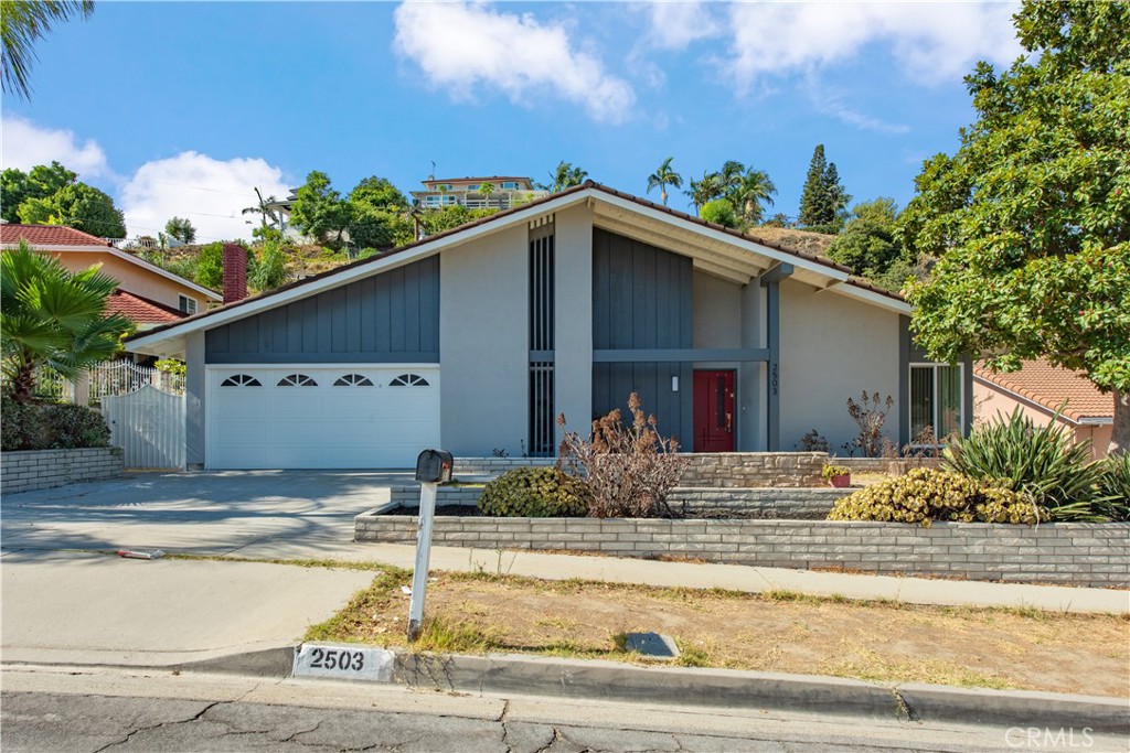 Welcome to 2503 Donosa Drive, a beautifully renovated single-story home in the heart of Rowland Heights. This move-in ready residence blends sophisticated upgrades with warm, inviting details — creating the perfect space for modern living.
As you step inside, you're greeted by vaulted ceilings and an abundance of natural light that fills the open-concept living and dining areas. The newly installed wide-plank luxury flooring adds warmth and continuity throughout, while recessed lighting and designer chandeliers elevate the ambiance.
The living room features a striking stone fireplace, offering a cozy focal point for gatherings or quiet evenings at home. Just off the living and dining areas, a convenient built-in wet bar with quartz counters and sleek brass fixtures adds a stylish touch for entertaining.
Down the hallway, you'll find beautifully remodeled bathrooms with contemporary finishes and thoughtful design, along with spacious bedrooms that offer both comfort and privacy.
Located on a quiet residential street just minutes from shopping, dining, schools, and parks, this home offers the perfect combination of location, style, and convenience.