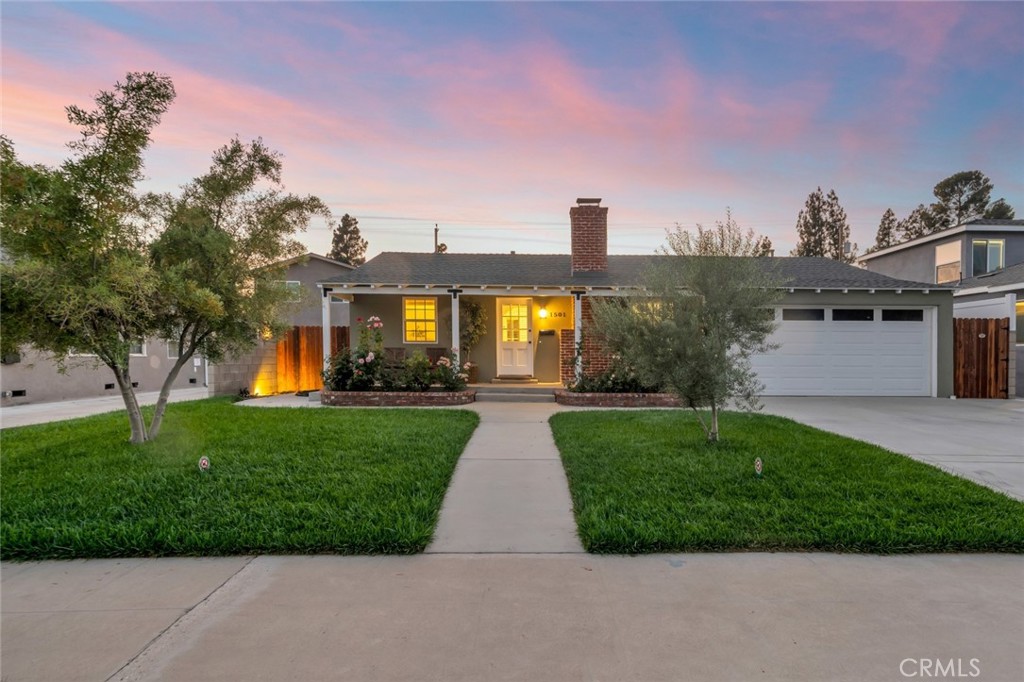 Step onto the wide front porch of this immaculate Burbank charmer and feel instantly at home. Every detail has been thoughtfully cared for in this 3 bedroom, 2 bath residence on a huge lot, featuring gleaming hardwood floors, dual-paned windows, with classic warmth and modern updates. The inviting living room with its fireplace flows to a dining area overlooking the covered patio and expansive, beautifully landscaped backyard—perfect for gatherings. The remodeled ¾ bath offers a large shower, while the full bath retains timeless appeal. A spacious kitchen boasts ample counter space and stainless steel appliances, complemented by a large utility room with extra cabinets for storage or pantry use. One of the bedrooms even features its own fireplace for added charm. Outdoors, enjoy a huge backyard with mature landscaping, two storage sheds, concrete walkways, with room for a pool and even an ADU! A two story 10 foot by 12 foot insulated Tuff Shed in the yard gives you additional storage. With an attached 2-car garage, tankless water heater, newer HVAC system as of August 2024, and upgraded 200 amp electrical panel, copper plumbing, this home is as functional as it is enchanting—a true Burbank gem where every detail shines.
