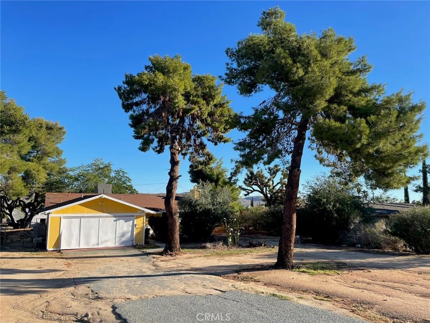 Welcome to this inviting 2 bedroom, 2 bath home tucked away in Yucca Valley's popular Story Park neighborhood. With its mature pine trees, colorful exterior, and peaceful desert setting, this property blends small town charm with plenty of potential. The main home features a comfortable layout with two nbeds,2 baths plus a garage that's been converted into two bonus rooms-perfect for a home office, quest space, or studio (buyer to verify permits). A newer rooftop A/C keeps things cool in the summer, and the roof itself is in great shape, giving peace of mind for years to come. Inside, the home is ready for your personal touch. Appliances are not included, there's no fridge, washer or dryer but that makes it a clean slate for your own kitchen style.

Located in one of Yucca Valley's most established and convenient neighborhoods, this home offers great value and endless possibilities-just minutes from local shopping, schools and Joshua Tree National Park. Owner will carry.