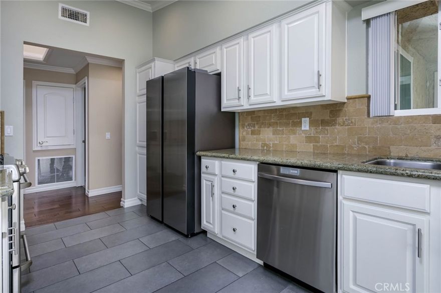 Highly Upgraded 2-Bedroom Home in The Hills! Zoned for Top-Rated Schools and Surrounded by Beautiful Scenic Views of Nature ... this Upper Level Single-Story Unit has High Vaulted Ceilings, Bright Skylights, Handsome Wood & Tile Flooring, Recessed Lighting & Crown Moldings Throughout - Up the Stairs & Open the Front Door to Spacious Living Room with Granite Fireplace - Formal Dining Room - Gorgeous Remodeled Kitchen Features White Cabinetry, Granite Countertops, and Newer Stainless-Steel Appliances, Including Refrigerator, Microwave, Dishwasher & Gas Cooktop/Oven - Breakfast Eating Nook - Large Primary Suite has a Walk-In Closet & En-Suite Updated Bathroom with Granite Vanity & Tile Shower - Second Bedroom is Also Good Sized with a Walk-In Closet - 3 Separate Sliding Glass Doors Lead to Wrap-Around Balcony with Panoramic Views of Hills & Trees - Convenient Laundry Room/Storage is on the Balcony with Stackable Washer/Dryer Included - Newer HVAC System - All Newer Dual-Pane Windows - Enjoy 2 Association Pools, 3 Spas, Tennis Court, Well-Equipped Fitness Center & Tot Lot Playgrounds Throughout The Hills Community - This Unit Includes 2 Reserved & Covered Carports, Plus Ample Guest Parking Spaces - Easy Access to the 91 Freeway & 241 Toll Road, As Well As Savi Ranch Shopping Center - Award-Winning Placentia-Yorba Linda School District, Zoned for Bryant Ranch Elementary, Travis Ranch Middle & Yorba Linda High Schools