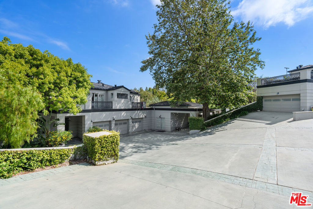 Step into coastal luxury with this expansive private double-gated estate in the heart of Point Dume, one of Malibu's most coveted neighborhoods. Offering exclusive Riviera 1 beach key access through the Zumirez gate with dedicated parking and storage for surfboards and beach gear this property delivers the ultimate in Malibu convenience and lifestyle. Spanning approximately 8,000 square feet across two residences, the estate is designed for grand living and entertaining. Soaring 18-foot ceilings, gallery-style walls for art, and a sunlit living room with fireplace create an elegant yet welcoming atmosphere. A chef's kitchen anchors the home, seamlessly connecting to multiple formal and casual living areas, a spacious office/library, and a gym. Upstairs, each bedroom opens onto a private balcony with peaceful treetop views. The primary suite offers dual bathrooms and generous closets, ensuring comfort and privacy. The home sits on over an acre of flat, park-like grounds, with lush gardens, a secluded swimming pool, and a fully equipped outdoor kitchen ideal for gatherings. A dual-entry motor court and ample gated parking make entertaining effortless. A two-story guest house provides an additional two bedrooms, two bathrooms, and its own two-car garage perfect for guests, staff, a studio, or creative workspace. Sustainable features such as solar power, recycled water systems, and a three-phase EV charging station deliver modern efficiency with almost zero utility costs. Point Dume is known for its vibrant yet tranquil community, blending everyday relaxation with adventure. From world-class surfing and private beach days to nature walks overlooking Big Dume Beach, this is Malibu living at its finest where every day feels like a vacation.