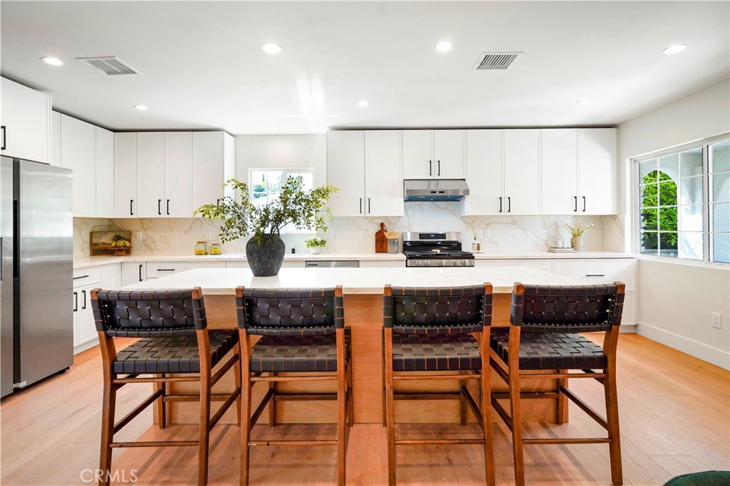 Seller Financing Available w/20% down payment!! Price Improvement! Turnkey, Extensively Remodeled Gem in Prime Tarzana! Step into this beautifully remodeled home where no detail has been overlooked. Featuring an open-concept floorplan, this residence boasts a stunning chef’s kitchen complete with quartz countertops, two-tone cabinetry, an expansive center island, stainless steel refrigerator, dishwasher, and sink, plus a brand-new gas oven and stove. Brand-new laminate flooring flows throughout, complemented by extensive recessed lighting and dual-pane windows that bathe the home in natural light. The spacious step-down family room offers a cozy retreat with a dramatic floor-to-ceiling rock fireplace—perfect for relaxing or entertaining. The primary suite is a private oasis, featuring a large walk-in closet and a luxurious en-suite bathroom with dual sinks and designer finishes. The hall bathroom is equally impressive, featuring a lighted mirror, stylish tub/shower combo, and two separate alcoves. Enjoy upgraded central ac and heat, electrical panel, copper plumbing, a huge separate utility room, and beautiful touches like shiplap accents in the formal dining area and primary bedroom. Outside, the newly landscaped backyard includes lush green grass with room for kids to play, a storage shed, and mature fruit trees in the front. An oversized driveway provides ample parking, and the stylish front door adds a warm welcome to this private, move-in-ready home. With plenty of cabinet and counter space, updated systems, and thoughtful design throughout—this is Tarzana living at its finest! This property is for lease as well for $5390.00 per month with a one year lease.