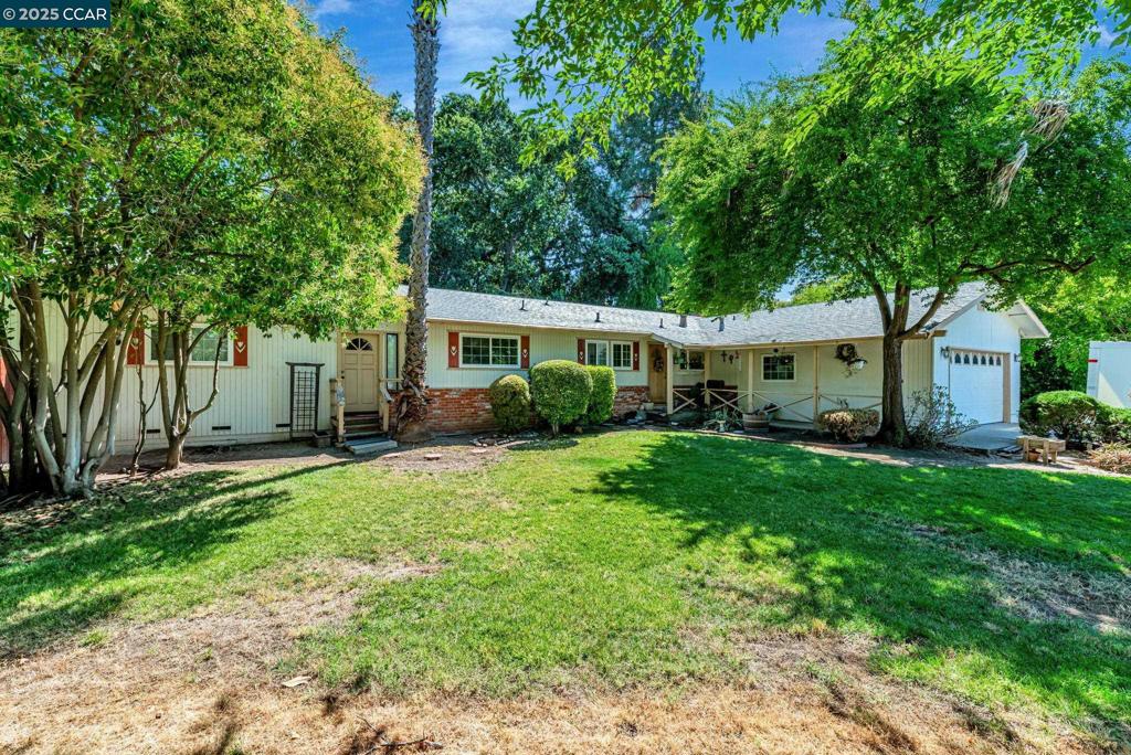 Welcome to this spacious single-level home, tucked at the end of a quiet cul-de-sac in Concord’s sought-after Four Corners–Ygnacio Valley neighborhood. This charming residence offers: 4 bedrooms and 3 full baths, including a spacious in-law/ADU suite with a private entrance—ideal for multigenerational living, generating passive income, hosting guests or serving as a primary retreat. Expansive rear grounds that create a true outdoor oasis—perfect for hosting special occasions or simply unwinding in peace. A thoughtfully designed indoor-outdoor flow that makes this home a serene sanctuary built for creating lasting memories. An open-concept floorplan featuring a cozy brick fireplace and a mix of hardwood, tile, and carpet flooring. Attached two-car garage plus extended driveway space—perfect for RV or boat parking. The kitchen features tile countertops and built-in cabinetry. This home blends comfort, flexibility, and opportunity. It's perfect for buyers seeking a livable space with solid bones and great potential. With a bit of renovation, you can turn your vision into reality and transform it into your dream home. All this, minutes from Walnut Creek, top-rated schools, parks, and shopping centers. Schedule your private tour today!