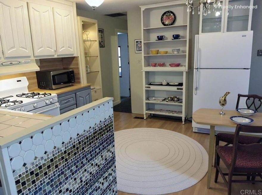 Incredible value in top active adult community!   This quaint home features solid surface floors, open kitchen, 2 full bathrooms (separate shower and tub), stackable washer and dryer, 2 spacious bedrooms plus a bonus/California room. Enjoy the perfect, year-round weather in Oceanside! Covered carport to protect your vehicle, plus a shed to store your gardening tools or surfboard!  Enjoy the weather outside on the patio. Some rooms have been virtually staged as noted.  Rancho San Luis Rey features a clubhouse with many regular social activities, heated pool, gym, and more! Shopping and restaurants are super close by. Purchase furnished or unfurnished!  Call now! Serial 2605