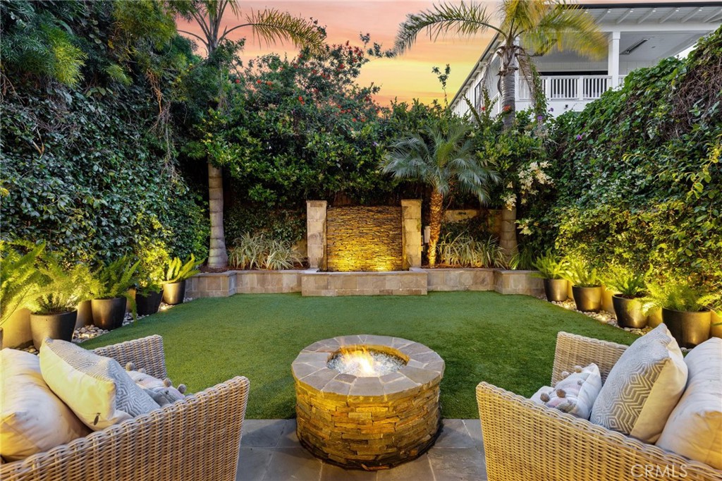 Welcome to 721 12th Street, an exquisite property with unbeatable walkability in the heart of Manhattan Beach. This home features an elevator, providing convenient access to all levels. The lower level, previously a separate studio, has been seamlessly connected to the main house. A La Cantina door spans the entire back side flooding the area with natural light. The addition of a wine closet, bar, and granite-topped kitchen, along with custom-built cabinetry, a queen-size wall bed, and built-in desk, maximizes the functionality of the space for various uses from entertaining to guest accommodations. This space is separate from the primary living area. Outside, the private backyard unfolds as an oasis showcasing a tranquil waterfall, stone gas fire pit, and turf lawn epitomizing indoor/outdoor living at its best. Ascending to the second floor you'll discover the primary retreat, a true haven of comfort and style. This suite has been thoughtfully designed, with a private balcony, fireplace, and a spacious walk-in closet adorned with cabinetry. The primary bath is spa-like, with a large tub and a spacious stand-in shower with pebble floor. You'll find two more bedrooms with Juliette railings and a full bath on this floor. Additionally the laundry room has been enhanced with granite countertops and cabinetry. On the upper level, the kitchen has been beautifully renovated with Taj Mahal quartzite counters. The addition of a new Sub-Zero fridge, wine fridge, along with a Thermador range and oven, elevate the cooking experience. A breakfast nook featuring a built-in bench and surrounding windows with ocean glimpses provides a cozy spot for morning meals or relaxed get-togethers. Adjacent, an ocean peek patio offers serene views. Additionally, a spacious outdoor patio accommodates al fresco dining for up to 6 guests. A walk-in pantry ensures generous storage for all your essentials. Also on this level is the office/5th bedroom thoughtfully designed with built-in bookshelves, cabinetry, and a desk, creating a productive and inspiring workspace. An oversized balcony provides a serene escape with breathtaking views of the backyard and mountains. This property is a rare treasure offering an unmatched fusion of elegance, functionality, and thoughtful design, complemented by its proximity to downtown, the beach, and local schools, making it an ideal location for enjoying the vibrant community.
