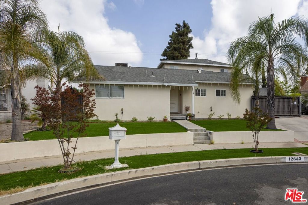 Welcome to this spacious 4-bedroom, 3-bathroom residence offering over 2,290 square feet of beautifully maintained living space. Thoughtfully designed for comfort and versatility, this home features an open-concept layout with expansive living and dining areas, ideal for both everyday living and entertaining. The kitchen is equipped with warm wood cabinetry, granite countertops, and stainless steel appliances, providing both style and functionality. A tankless water heater was just installed for the whole house. Rich hardwood and tile flooring run throughout the home, complemented by recessed lighting and ample natural light that enhances the warm and inviting atmosphere. Each bedroom offers generous dimensions, including a large primary suite with plenty of closet space. Additional highlights include a flexible bonus room perfect for a home office or creative space, and a private, gated backyard that has been thoughtfully set up for outdoor enjoyment or recreational use. Currently operating as a licensed childcare facility, the property presents an excellent opportunity for continued use or seamless conversion back to a traditional single-family layout, depending on your needs. Centrally located near local amenities, schools, and shopping, this home combines comfort, space, and potential perfect for a variety of lifestyles. A standout opportunity in North Hollywood with flexible use options.