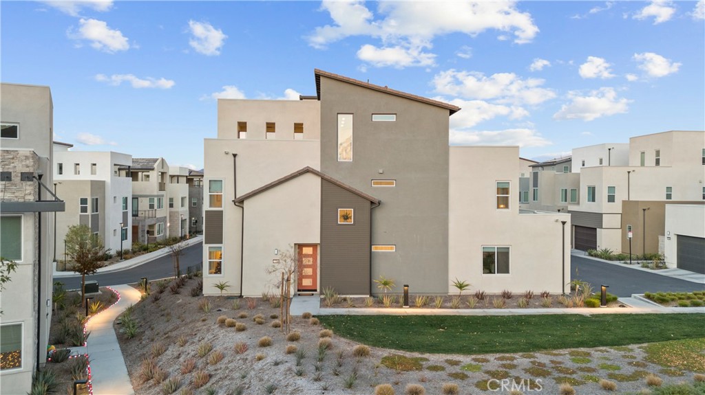 MUST SEE... breathtaking in person! Step into this exceptional, corner residence and prepare to be captivated by the stunning panoramic views! Situated on a prime lot, this immaculate, 5-bedroom home offers a wealth of upgrades and is a true showstopper. Upon entering, you'll be greeted by a contemporary front door opening into a luxurious interior adorned with quartz countertops, top-of-the-line stainless steel appliances, premium window treatments, and exquisite engineered oak flooring. The main level of this home is a testament to sophistication, with a spacious living area, a gourmet kitchen, and an attached garage. Plus, a delightful surprise awaits with a full bedroom and bathroom on this level, along with a California room featuring sleek and versatile pocket doors that seamlessly integrate indoor and outdoor living. Step outside to discover the expanded low-maintenance side yard, ideal for relaxation and entertainment. On the second level, the generously proportioned primary suite beckons with a walk-in closet and a lavish en-suite bathroom. Three additional well-appointed bedrooms offer ample space and comfort, each adorned with premium carpet and upgraded Tempurpedic padding. Moving up to the third floor, you'll find an entertainer's paradise, complete with a built-in bar, wine refrigerator, a fifth bathroom, and a spacious balcony offering captivating sunset and mountain views. The 2-car plus EV garage is not just a practical space, but a versatile one too, boasting extra climate-controlled office space, indoor/outdoor carpeting, and overhead storage. This home is equipped with smart technology features, including a Schlage Encode Smart Wi-Fi Deadbolt, Ring Video Doorbell Pro, Ring Alarm Security Kit, Honeywell Home T6 Pro Z-Wave smart thermostat, and Legrand On-Q RF Transparent Structured Media Enclosure. Throughout the entire home, decorative wall panels, recessed lighting, and energy-efficient dual-paned windows create an inviting and sustainable living environment. As part of a vibrant community, residents have access to an array of amenities, including pools, a community garden, playgrounds, walking trails, and regular community events. Don’t miss the opportunity to make this extraordinary abode your own. With a low HOA of just $240 per month, this home is truly something special. Don’t let this opportunity slip away!