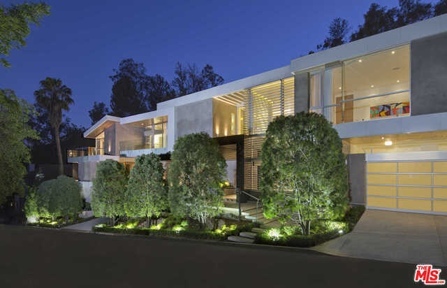 Meticulously crafted brand new construction, this architectural off the Sunset Strip was conceived with an eye toward leisure and modern design. Beyond the home's front door and floating staircase is a setting both serene and powerful, where glass elements allow the natural surroundings to flow freely and create a dramatic visual experience. Fleetwood pocket doors seamlessly integrate private, sun-drenched grounds with water features, zero edge pool & cabana. An entertainer's dream, the formal dining room is joined by a 21-ft motorized wine rack that allows a treasured vintage to travel from the upstairs master wing to the table at the push of a button. Furthermore, the sprawling basement level evokes an upscale lounge with theater, gym/sauna, and full bar offering a view into the pool overhead as well as the 7-car gallery. This residence also includes maids quarters, an additional 2-car garage, and is strategically priced at less than $1,400 SF with a great history of lease income.