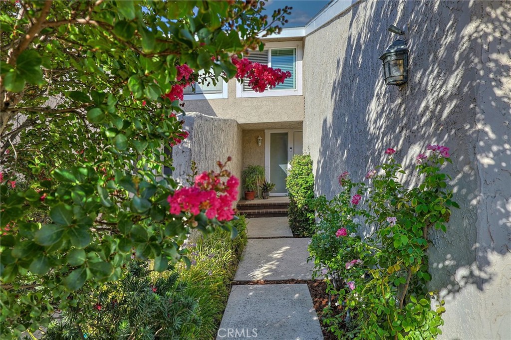 Welcome to your dream retreat in Valencia! This beautifully updated 3-bedroom, 3-bathroom home spans 1,859 square feet and is tucked away in the rear corner of a secure, gated community. Attached by only one wall, the property boasts what’s believed to be the largest yard in the community — a private oasis brimming with fruit trees and vibrant seasonal blooms. Step into a light, bright, and airy interior, where new Pella windows and sliding doors flood the home with natural light. Every inch has been thoughtfully reimagined: the kitchen and bathrooms gleam with granite and marble finishes, sleek cabinetry, and modern stainless-steel appliances. The oversized primary bedroom ensuite bath feels like a private spa, featuring a luxurious custom walk-in shower. Outside, enjoy the extensive hardscaping and edible landscape, offering tranquil moments surrounded by pomegranate, fig, pear, and more. The community has seen major updates, including new roofs and soon-to-be-completed pool and spa renovations. Just minutes from shopping, schools, the hospital, College of the Canyons, the mall, and freeway access — and perfectly positioned near the scenic Santa Clarita Trail System — this home offers a lifestyle of convenience, beauty, and peaceful privacy.