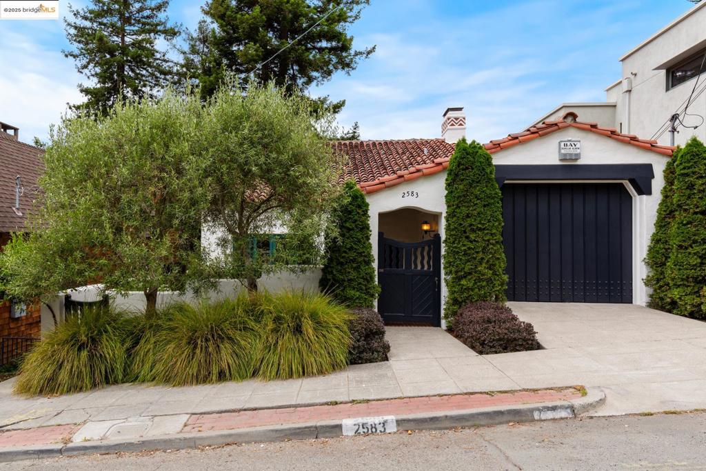 Designed by Walter Ratcliff, chief architect for the City of Berkeley in the early 20th Century, this extraordinary 1929 Mediterranean combines exquisite design and craftsmanship, lush and lovely gardens, and sweeping North Bay views. Beyond the secluded courtyard entry, the grand foyer introduces the architectural themes: soaring spaces, rich wood beams and details, leaded glass, and intricate ironwork. Ascend the open staircase to the magnificent Great Room with vaulted ceiling, sculptural stone fireplace, and floor-to-ceiling French doors to its balconies and vistas. Like the Great Room, the adjacent library/study is lined with handsome bookshelves. On the main level, the family room opens east to the courtyard and west to the tastefully updated kitchen open to a generous dining area with a balcony and treetop bay view. Two charming view bedrooms, one with a fireplace, and an artfully tiled hall bathroom complete the main level. Below, down a graceful, open staircase, the large and light-filled primary suite opens to the rear deck and leafy garden patios anchored by a towering redwood tree. Lovingly maintained over many decades, this uniquely beautiful home invites lovers of architecture to this very special neighborhood close to all North Berkeley pleasures.
