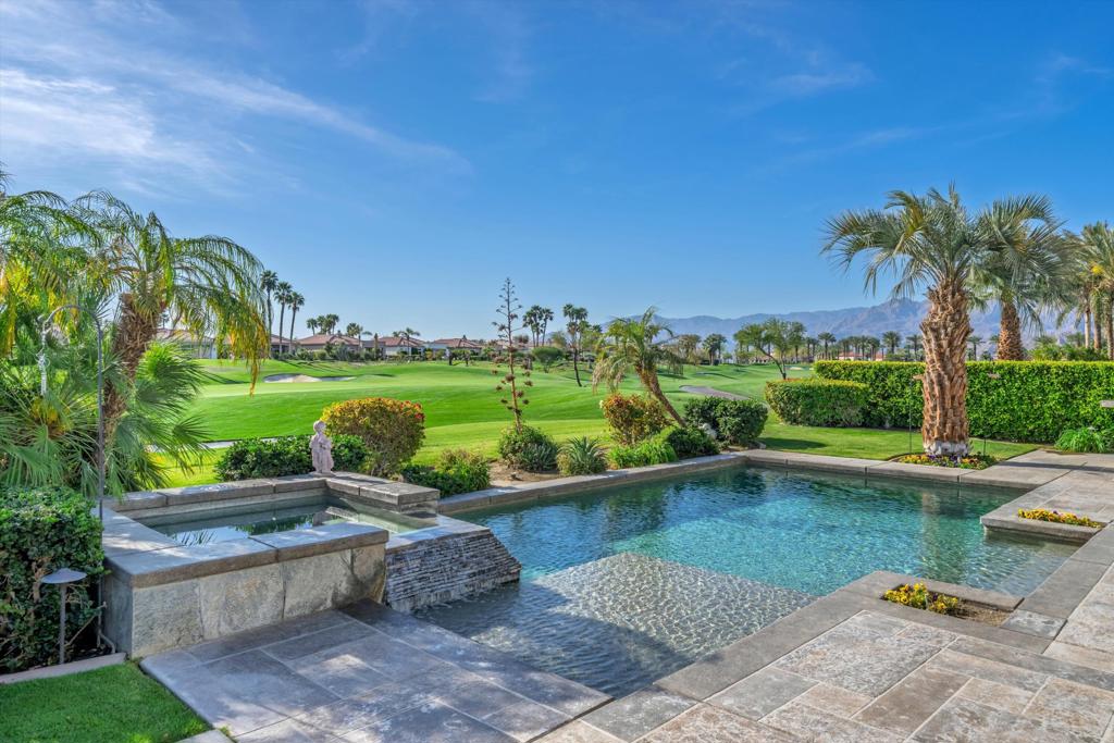 Stunning golf course estate in the prestigious Mountain View Country Club, where sophisticated design meets resort-style living. This elegant 3,267 square foot Piedra model showcases panoramic views of the Arnold Palmer Signature course and dramatic mountain vistas from nearly every room. The refined interior features marble floors, soaring ceilings, and walls of glass that frame the majestic landscape. The open-concept great room flows seamlessly to a gourmet kitchen with custom cabinetry and premium finishes. Four bedrooms include a luxurious primary retreat with spa-inspired en-suite and expansive walk-in closet. A dedicated office/den adds flexibility to the thoughtful floor plan.Step through glass doors to an entertainer's paradise - a covered patio overlooks the custom pool and spa, surrounded by professional landscaping and unobstructed fairway views. The private courtyard entry, three-car garage, and designer touches throughout complete this exceptional residence.Located within the gates of Mountain View Country Club, owners enjoy immediate golf privileges (no wait list), championship tennis courts, state-of-the-art fitness center, and a stunning clubhouse. Minutes from world-class dining and shopping, this turnkey property represents desert luxury at its finest.Schedule your private tour today and experience all this home has to offer. Don't miss the opportunity to own this exceptional desert retreat!