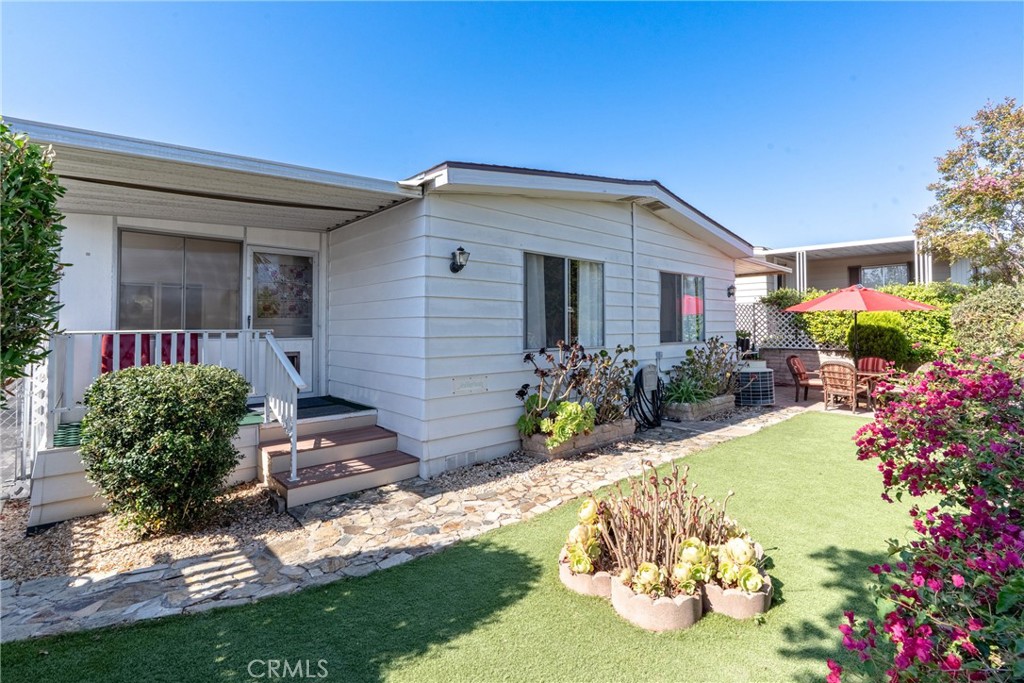 Own your land. No space rent. Located in a desirable 55+ community, this beautifully maintained two-bedroom home offers a spacious and functional layout with a welcoming atmosphere. The large living room and separate family room provide versatile spaces for relaxing or entertaining, while the central AC and heating ensure year-round comfort. At the heart of the home, a big island kitchen offers generous counter space and cabinetry, making it perfect for cooking, hosting, and everyday living. From the kitchen, enjoy easy access to the expansive backyard with scenic views, ideal for outdoor dining or quiet afternoons. The oversized front porch adds even more space to unwind and welcome guests.
Practical features include a full-size washer and dryer, a large storage shed, and extra storage space. Just a short walk away, the community clubhouse and pool offer a refreshing escape, while additional amenities include a gym, library, and RV parking. The HOA covers water, trash, cable, and high-speed internet for added convenience. Perfectly located near Elfin Forest, this home is also close to restaurants, shopping, and outdoor recreation. A wonderful opportunity to enjoy comfort and convenience in a sought-after neighborhood.