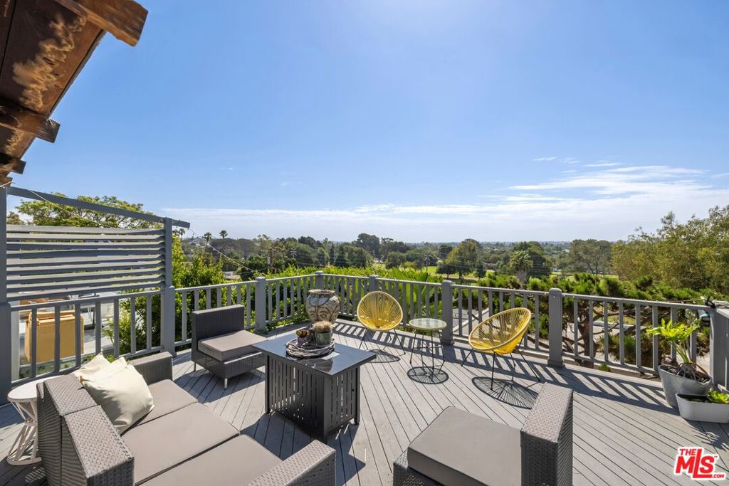 Stunning Sunset Park Residence with Panoramic Views Perched above Penmar Golf Course, this exceptional Sunset Park home captures sweeping city and ocean vistas from its light-filled interiors and expansive outdoor spaces. Designed for both comfort and elegance, the residence offers three bedrooms plus a versatile bonus room and two full baths. The main level welcomes you with an airy flow to the spacious patioan ideal setting for entertaining or quiet sunset evenings. Two bedrooms, including a large bonus/flex space, and one full bath complete this level. On the lower level, discover two additional bedrooms, highlighted by the primary suite with a private fireplace and serene outlooks. The generous street-to-street lot is beautifully landscaped with drought-tolerant gardens and provides convenient off-street parking for two cars. With its exceptional views, timeless style, and prime Sunset Park location, this home offers a rare opportunity to enjoy the best of Santa Monica living.