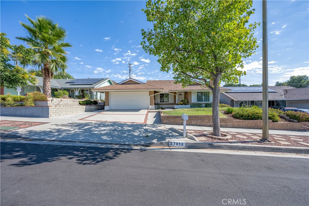 This rare five bedroom, single story home is ready for you to make it your own! Stepping inside you'll find a well designed floorplan that expertly utilizes every on of the 1,809 square foot of living space on offer. Serving as the heart of the home, the centrally located common areas feature dedicated dining, living and family rooms arrayed around the spacious kitchen. With a full five bedrooms, there are no shortage of possible configurations that this home can accommodate - from hobby rooms to home office setups and of course just classic bedrooms for family or visitors. The meticulously maintained back yard, complete with a covered patio and premium pavers, is perfect for enjoying Southern California's beautiful year-round weather, and offers terraces and planters, ideal for indulging those with a green thumb. Adding even more value, this home boasts several major upgrades 'under the hood' that have been done within the last few years, including: New HVAC, an upgraded Electrical Panel, new Attic Insulation, upgraded Windows and Sliders, a complete Re-Pipe, and new Sewer Line; all in representing tens of thousands of dollars in value! And of course, the amazing location means all Santa Clarita has to offer - including great dining, shopping, parks and award winning schools - are all close at hand!