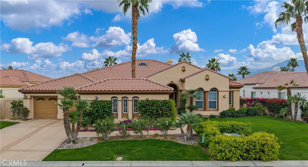This specially cared for PGA West home sits on a SECLUDED, LARGE LOT that measures over a third of an acre, and is situated ABOVE the 14th tee box with sweeping SOUTHERN double fairway VIEWS of the Greg Norman Golf Course and Santa Rosa Mountains. The backyard has been completely REMODELED with COOL travertine stone DECKING, mature palms, native plants, pebble tech pool with waterfall, spa and two heaters, fire chat area, built-in barbecue, California room with recessed overhead, infra red heaters, automated awning and misters for YEAR-ROUND, OUTDOOR ENJOYMENT. The Toll Brothers Mendocino plan is a spectacular home that begins with a welcoming porch and calming fountain leading into a GRAND FOYER of polished travertine. Its unique floor plan feels open and spacious with its 12' high ceilings, offering VIEWS out to the yard and pool, and flows easily from one space to the next: A formal dining area with a dramatic 20' high skylight, an inviting living room anchored by an elegant fireplace, an entertainer's wet bar with ample seating, a casual lounge area with built in book case and TV, and of course, a gourmet kitchen with island, walk-in pantry, and breakfast area. The primary suite also overlooks the pool and views of the golf course and has its own backyard access. It includes an en suite bath featuring a luxurious Roman therapeutic whirlpool tub, separate shower and dual vanities, plus walk in closet with high end built-ins. There is a 2-car garage plus adjacent full size golf cart garage so you can easily commute to all 6 world-renowned golf courses within the community. HOA includes 24-hour attended security gate, front & backyard landscaping and water, front yard lighting, expanded cable & Internet package.