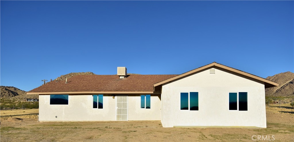 Spacious home on a large spacious five acre lot tucked away in a remote canyon just minutes from downtown Joshua Tree. Also on the property is a 4 car detached garage with power that can be used as a work shop also. Only 5 minutes to downtown Joshua Tree in area with very little traffic. Unique offerings like this rarely come on the market. For those seeking a private, remote location, and plenty of land this one is for you.