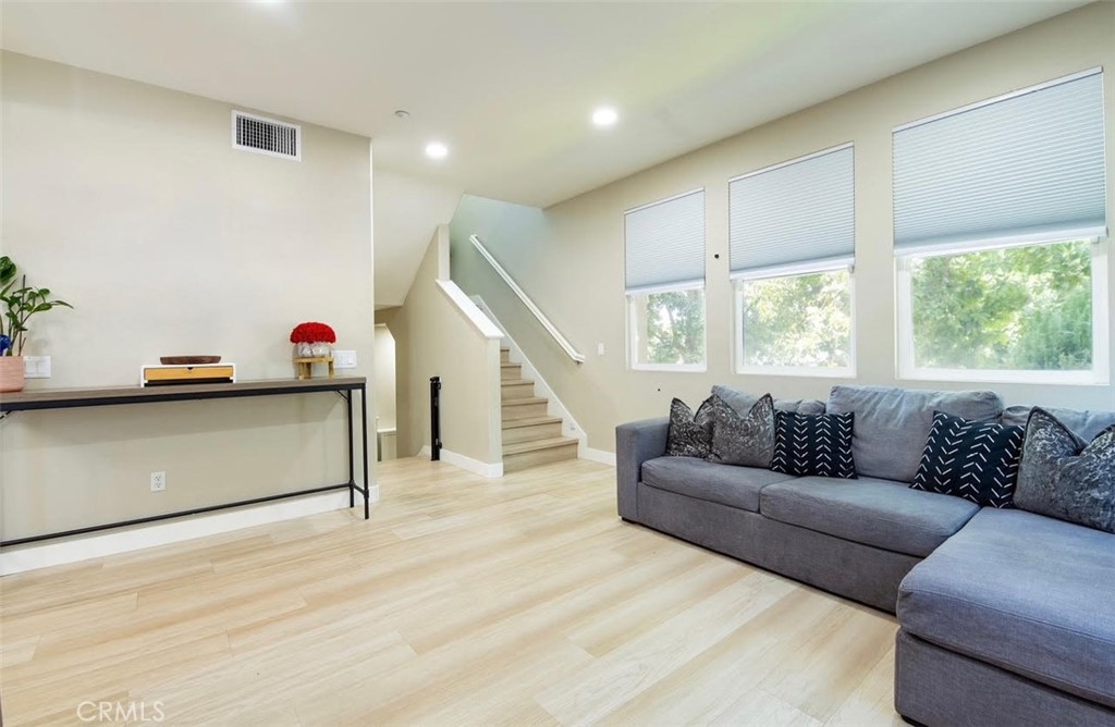 This stunning three-story home in Willow Walk Community offers a secure living environment with an inviting entryway leading to a spacious second floor featuring an open living room, half bath, dining room, and modern kitchen with granite countertops and wooden cabinetry. The home includes a serene patio with an anti-theft sliding door, while the third floor boast a master bedroom with an in-suite bathroom, an additional bedroom, and a full bathroom. Renovated with upgrades like new flooring, LED vanity mirrors, recessed lighting, custom windows screens in entry, and security features, it also includes an attached two-car garage and various negotiable amenities like a Tesla charger and water filtration system. Residents can enjoy a common dog park and playground, with 24/7 security access, making this home a perfect blend of comfort and safety.
