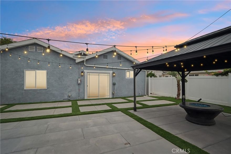 Imagine a single-level stunner with a designer’s touch. This 3-bedroom, 3-bath beauty will have you captivated from the curb. Stacked stone walls, meticulous dryscaping, and a wide front yard set the tone as you arrive on this picturesque, tree-lined street. A terraced pathway leads to the sizeable porch, ideal for showcasing seasonal decor or chatting with passersby. Inside, wide-plank floors stretch under vaulted ceilings, with recessed lighting and crisp white hues giving the home an effortlessly modern air. The flow is seamless between the sunlit living room illuminated by bright windows and a refined dining hall, where built-in display shelves, a tray ceiling, and a dry bar stand ready for intimate celebrations. Your kitchen is equal parts function and flair: track lighting spotlights every culinary move, and the luminous countertops shine beside stainless steel appliances and an oversized sink. A waterfall-edge multi-seater peninsula gleams beneath pendant lights, inviting conversation while delicacies take shape under diligent hands. In the generous step-down family area, skylights crown soaring ceilings, while an accent wall creates a counterpoint to sliding glass doors that frame the connection to a private oasis. Your entertainer’s backyard is a secluded haven, whether gathered under the gazebo beside the fire pit or enjoying quiet evenings sipping cocktails on the custom hardscaping bordered by living pathways. When it’s time to unwind, tranquility can be found in any of the well-proportioned bedrooms, each with a contemporarily designed bath conveniently at hand. Double doors lead into an art-deco-inspired primary suite, where patterned tile floors shimmer with mother-of-pearl detailing. A chic pony wall with a glass topper separates the main section from stylish dual vanities, an integrated makeup station, and a rainfall shower with a bench, offering a resort-like experience every morning. Beyond a freestanding partition, an elegant chandelier glows over a sitting alcove and wardrobe area for moments of calm before venturing directly out onto the patio to join the gathering. Beyond the main residence, a detached structure has been transformed into a 1-bedroom suite with its own entry and courtyard. Notables include the pull-through garage, central heating, solar panels, laundry room, and an expanded driveway. Come experience the blend of

artistry, function, and comfort that makes this Torrance treasure unlike anything else!
