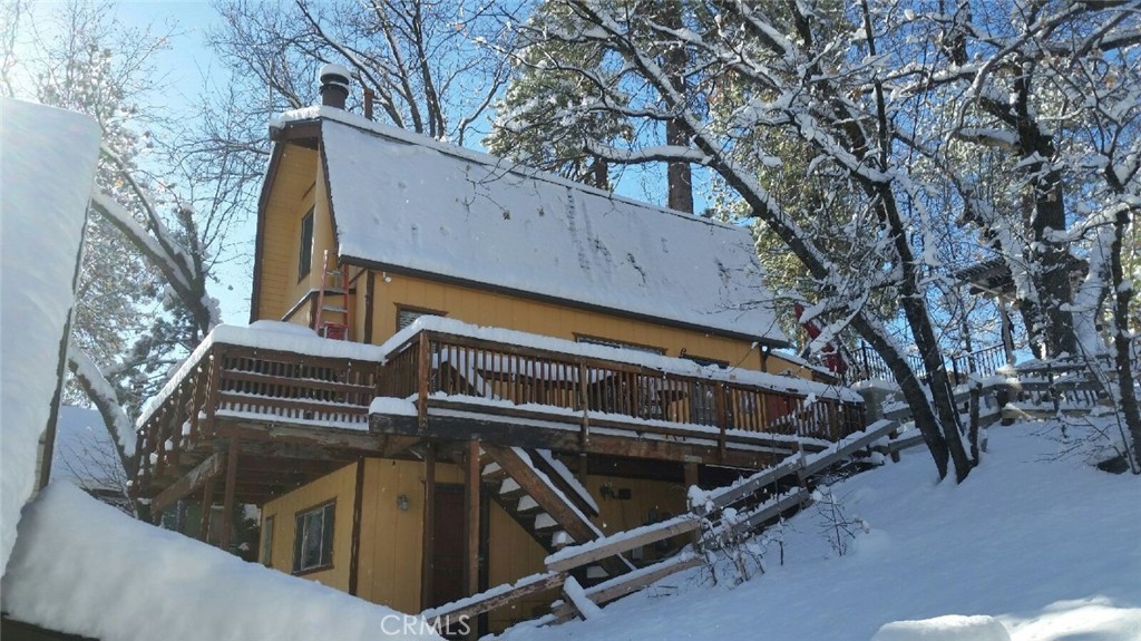 Cozy cabin in Arrowbear. Maybe an Air BNB?? Three bedroom with 2.5 baths. The main level has 2 bedrooms with 1.5 bathrooms. There is an outside access to lower level with one bedroom with 1 bathroom. Fireplace on the main level. Storage area in front. Parking area in front. Central heat. Washer/Dryer included in the basement adjacent the lower bedroom area. Has a private road entry. The cabin furniture is negotiable. Just behind the Deep Creek Drive in.