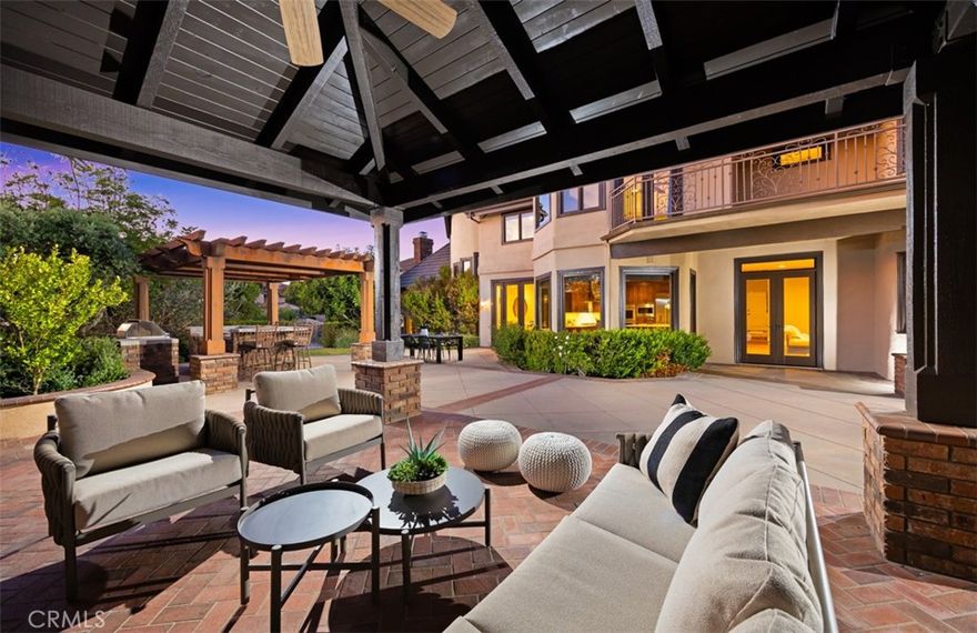 Nestled within the prestigious Hidden Mountain Estates, this exquisitely reimagined 5-bedroom, 2-2-1-bathroom residence marries timeless sophistication with modern luxury, set upon a rare, flat, nearly half-acre lot where an elegant, sweeping driveway wraps gracefully around the home. Privately tucked away with picturesque views, the home is designed for both grand entertaining and everyday living. A welcoming foyer reveals dual staircases and a spacious main-floor office, while the remodeled chef’s kitchen takes center stage with custom cabinetry, a built-in Sub-Zero refrigerator, an expansive island, and a light-filled breakfast nook. The sprawling master retreat is a true sanctuary, complete with a double-sided fireplace, a wet bar, and a serene sitting area. The luxurious spa-inspired bathroom features a Jacuzzi tub, an oversized walk-in shower, and dual granite-topped vanities, along with abundant closet space. Each secondary bedroom offers the convenience of an ensuite bath, including a downstairs guest suite and an upstairs bedroom that connects to a bonus room—ideal as a playroom, study space, or teen hangout. Expansive living and dining areas flow seamlessly through French doors to the professionally landscaped backyard, where a covered fireplace lounge and built-in barbecue set the stage for effortless outdoor gatherings. With space for a future pool and thoughtful updates throughout—including new flooring, carpeting, window treatments, and fresh paint—this light-filled home embodies a perfect blend of style, comfort, and meticulous detail.