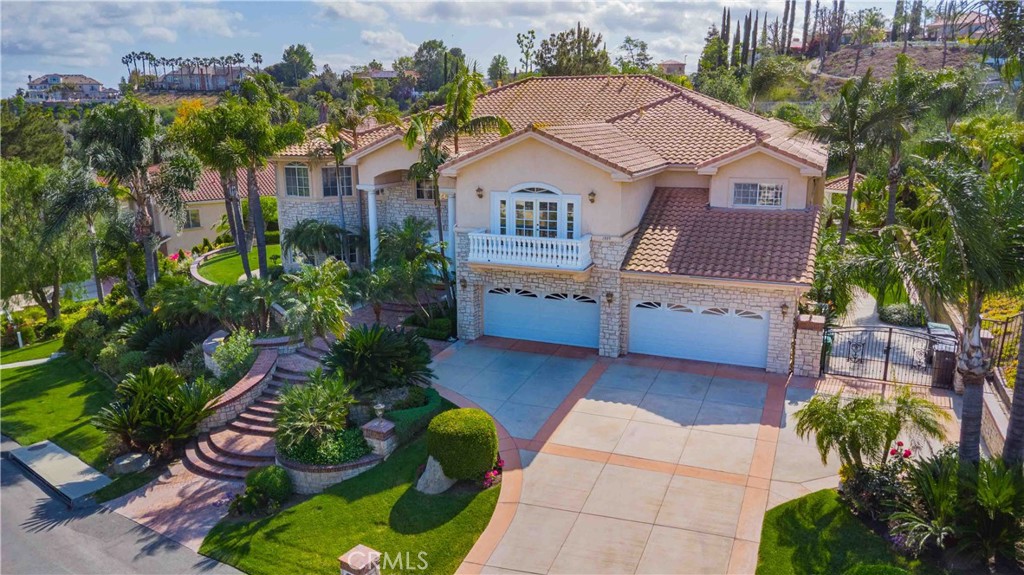 This exceptional estate, with original owner, located in the prestigious gated community of The Country, spans two parcels and boasts six luxurious bedroom suites, offering unparalleled comfort and privacy. An office with a full bath that can be used as the second downstairs bedroom suite, and an elegant, well-appointed powder room conveniently located between the formal living room and spacious family room, making it ideal for entertaining.
A dramatic two-story grand entry with a crystal chandelier welcomes you. Wide double staircases leading to different sections of the upper level set an impressive tone upon arrival.
The formal living and dining rooms provide generous spaces for gatherings, while the family room is equipped with a custom-built-in entertainment center and is seamlessly connected to the large open kitchen, breakfast nook, a couple of cozy conversation sitting areas, and a gorgeous wet bar with a table for wine tasting.
The gourmet kitchen is a chef’s dream, complete with dual center islands, custom cabinetry, and an adjoining wok kitchen for added culinary flexibility. Enjoy casual dining in the bright breakfast nook, perfectly situated off the open kitchen layout.
Designed for both everyday living and grand entertaining, this home offers a thoughtfully designed floor plan that encourages flow and connection. Crown molding throughout the home. Wide and open upper-floor hallway with wainscot paneling. The upstairs laundry room is conveniently located near all bedrooms, and a bedroom-sized storage room provides ample space for seasonal décor and miscellaneous items.
An expansive bonus area with paneled ceiling and walls is ideal for billiards, gaming tables, or displaying collectibles, offering endless opportunities for leisure and personalization. Custom window coverings throughout the home add a refined finishing touch.
Outside, the professionally landscaped grounds are a true oasis, featuring a resort-style pool and spa, gazebo, fire pit, flagstone walkways, tastefully placed plants, flowers, and many mature trees, plus a large grassy area perfect for recreation or relaxation. A four-car garage with built-in cabinetry ensures ample parking and organized storage.
This residence combines elegant design, practical functionality, and luxurious amenities — perfect for those who love to entertain and live in comfort.
