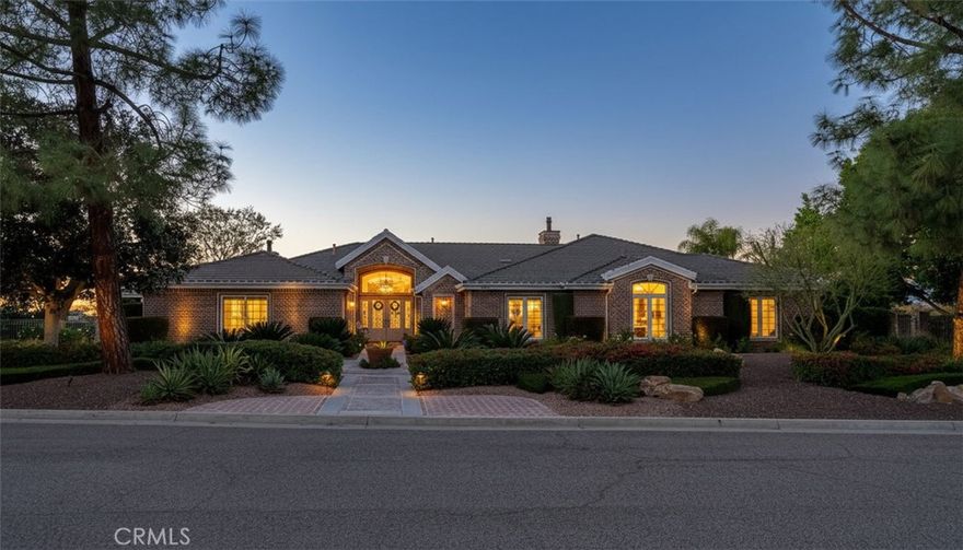 **ALESSANDRO HEIGHTS – WYNDHAM HILL ESTATES**  
This remarkable Modified Traditional Brick Ranch-Style Estate seamlessly blends luxury and comfort in a thoughtfully designed floor plan featuring grand living spaces and generously appointed bedroom suites. From the moment you step into the foyer, the home’s striking architecture captivates, complemented by breathtaking views of the Prenda Arroyo, Alessandro Creek, rolling hills, city lights, and majestic mountains beyond.

The formal living room, complete with a cozy fireplace, flows effortlessly into the elegant formal dining room. The heart of the home is the expansive great room, highlighted by a distinctive turned brick column fireplace and a chef’s dream kitchen. Here, a massive island, custom cabinetry, stone countertops, and professional-grade built-in appliances set the stage for culinary excellence and effortless entertaining.

The private primary suite is a serene retreat, complete with a tranquil sitting room, a two-way fireplace connecting the bedroom to the luxurious ensuite bath, a private lanai for soaking in the views, and ample space for relaxation. The additional bedroom wing offers spacious accommodations, each with an ensuite bath and generous closets, along with a convenient indoor laundry room. A separate guest wing, currently styled as a study, features its own private entrance and bath, making it ideal for visitors or multigenerational living.

Outdoors, the professionally landscaped grounds are a true oasis, designed with water-wise plantings and featuring a sparkling pool, spa, and putting green. The expansive deck offers both covered and open-air spaces, perfect for entertaining, with an outdoor fireplace and built-in grill ready for gatherings of any size. Additional highlights include a four-car garage, extensive off-street parking, and the energy efficiency of an owned solar system.

This one-of-a-kind residence offers an unparalleled combination of sophistication, functionality, and natural beauty—truly a place to call home.