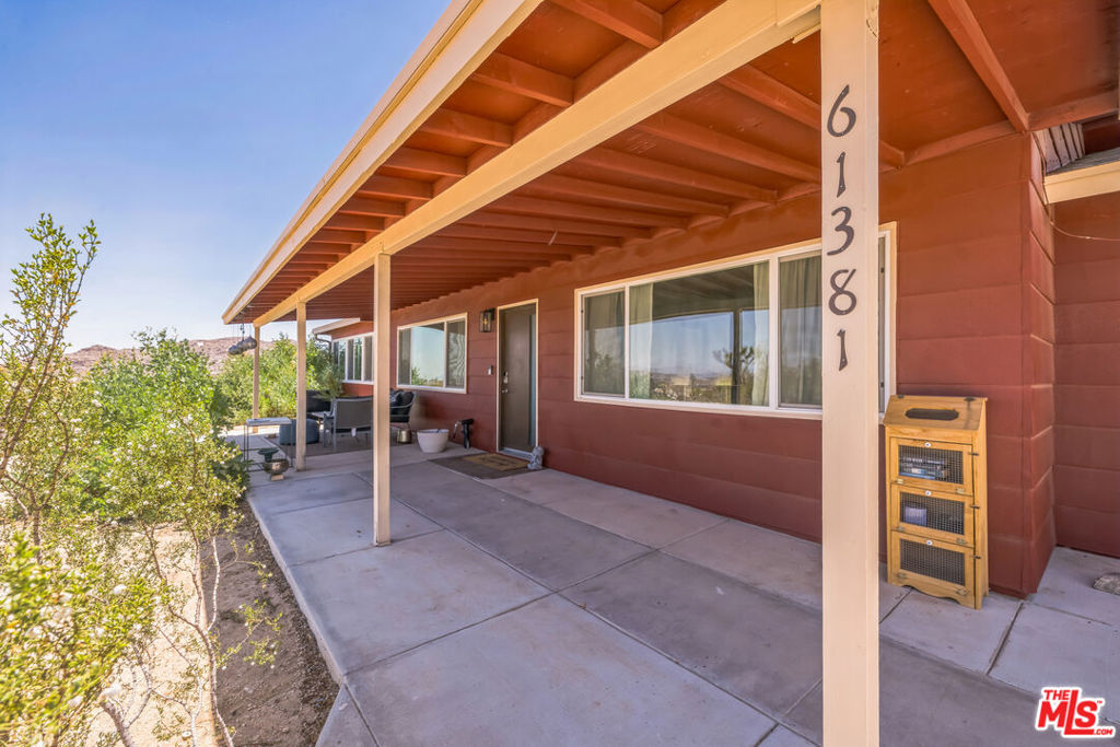 Perched high above the valley with unobstructed views, this stylishly updated Joshua Tree retreat embodies the essence of desert living with its breathtaking sunsets, sunrises, and star-filled nights. Situated on a generous 0.54-acre lot, the property provides ample space to roam, RV parking, and a two-car garage, making it both a perfect getaway and a strong investment opportunity. Offering approximately 1,200 square feet of living space, the home features a grandfathered addition that includes a spacious third bedroom, sunroom, and utility room, combining functionality with charm. Inside, playful design blends seamlessly with modern convenience, highlighted by a brand-new kitchen with open shelving, bold accents, and thoughtful details. Designer upgrades such as Toto toilets, Gehre faucets, custom sconce lighting, and durable tile flooring elevate the interiors, while the remodeled bathrooms feel fresh and inviting. Expansive windows and French doors frame dramatic desert vistas, and from the primary bedroom and sitting room, panoramic valley views stretch endlessly. Outdoor living is equally appealing with an extended concrete patio, ideal for morning coffee, al fresco dining, or evenings under the stars. Additional features include a new central AC system, an EV charging outlet in the garage, and a freshly painted exterior (Fall 2023). Just minutes from Joshua Tree National Park and the village, this home offers a rare blend of character, comfort, and potential perfect as a full-time residence, vacation escape, or income-generating property.