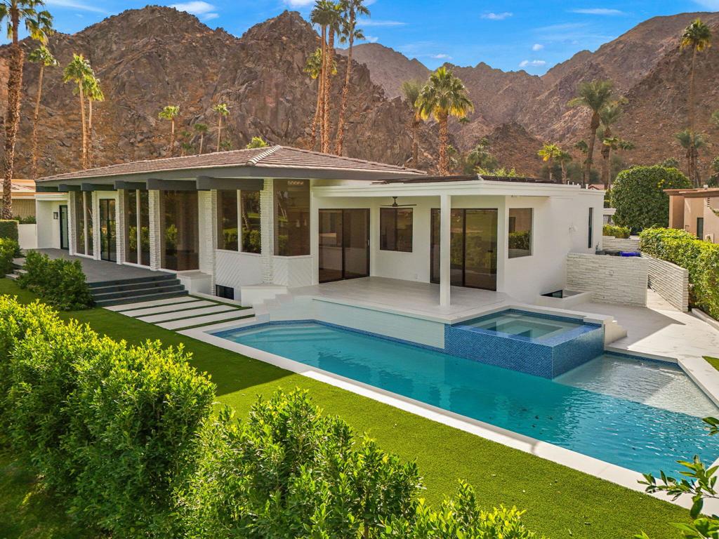 Fully remodeled Indian Wells Country Club golf course home with mountain views and no HOA!! Nestled in between the mountains and golf course sits this beautifully remodeled mid-century modern home. Reimagined for a modern convenient lifestyle, this home boasts all the latest comforts while retaining the classic architecture of the past. Views in every direction as you are surrounded by layers of mountains and the number 2 green of the historic Classic golf course played in the Bob Hope Classic. The backyard has been fully remodeled with new pool/spa and equipment, turf, Sonos speaker system, new exterior lighting, and landscape that provides privacy and views at the same time. Upon entry you will find 12 foot floor to ceiling solid glass pane windows. Natural light abounds throughout this open reconstructed design for ease of movement throughout the home. With new flooring, kitchen, and bathrooms, this light and bright home fulfill all of your needs. Entertain family and friends in the 3 main floor bedrooms with en suite bathrooms, or enjoy the basement bedroom with sitting/media/social room with a hidden wine cellar. There is also an office that could be used as a small fifth bedroom if needed. Creativity and craftsmanship has delivered this home to its current splendor. Live the Indian Wells golf course dream.