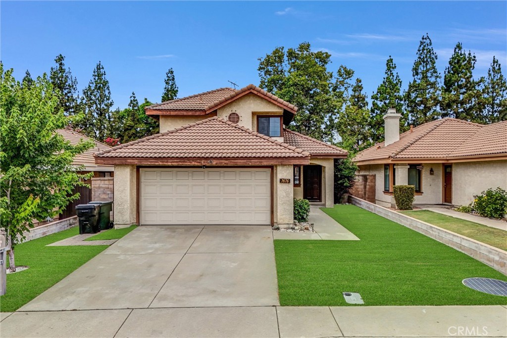 Welcome home to this wonderful 3 bedroom 2.25 bath home in the beautiful community of Terra Vista. Pride of ownership is evident on this well maintained cul-de-sac. The front yard features lush green, easy to maintain, drought friendly artificial turf. As you enter through the front door, you'll be impressed by the grand entry, sweeping staircase, and the living room that enjoys a high ceiling, cozy brick fireplace, dining area, and sliding glass doors that lead to the sunny enclosed patio. The delightful eat-in kitchen features granite counters with plenty of prep space, ample cabinet space, and a pantry. The large picture window provides a convenient pass-through for outdoor entertaining. The downstairs also features a spacious bedroom, a full bathroom with a large storage closet, a convenient indoor laundry, and a deep coat closet for more storage possibilities. The upstairs features 2 more spacious bedrooms, especially the primary bedroom suite that enjoys a high ceiling, vanity with linen storage, walk-in closet, and a French door that leads to the large balcony with stunning mountain and neighborhood views. The secondary bedroom has corner windows offering more gorgeous views. The large full bath features tile floors and a beautiful dark wood vanity. The generously sized backyard features a cement and brick patio and blockwalls. The direct access 2 car garage has a workbench and tons of storage cabinets. Conveniently located near schools, parks, and the Terra Vista Town Center with lots of shops, restaurants, and a movie theater. This home is a must see!