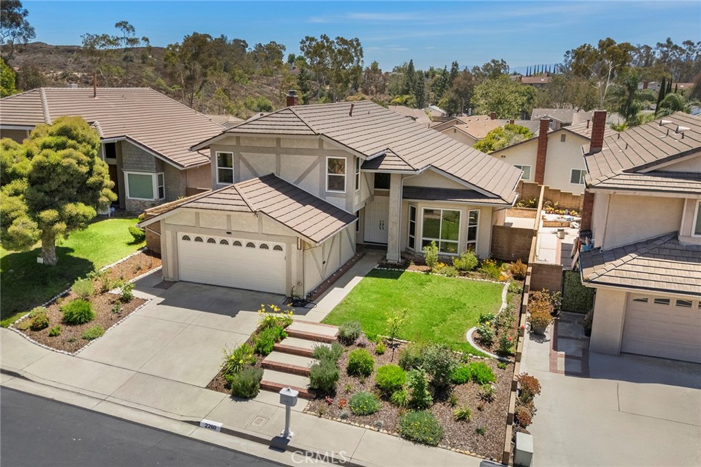 Tucked in a peaceful cul-de-sac within the highly coveted Coyote Hills Estates, this beautifully updated home offers the perfect blend of space, comfort, and convenience. Featuring 4 spacious bedrooms and 3 full baths across 2,293 sqft, including a rare main-floor en-suite, this floor plan is as functional as it is desirable. Step through grand double doors into a bright interior featuring vaulted ceilings, expansive dual-pane windows, brand-new vinyl flooring, and fresh interior paint. Formal living and dining spaces offer timeless charm, while the cozy family room and breakfast nook create the perfect atmosphere for everyday living. The oversized primary suite offers a serene escape with double vanities and a soaking tub. Enjoy a covered backyard patio perfect for relaxing or entertaining, with access to nearby walking trails at Robert E. Ward Nature Preserve. Resort-style HOA amenities include 2 sparkling pools, spa, clubhouse, tennis court, basketball court, playground, and scenic trails. All set within an award-winning school district, including Laguna Road Elementary and Parks Jr High and just minutes from shops, dining, and more. Don’t miss the opportunity to call this exceptional home your own!