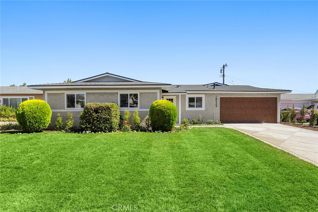 Tucked on a cul-de-sac in Rowland Heights, this charming single-story home blends comfort and style with a touch of farmhouse charm. Step inside to find a welcoming layout featuring 3 bedrooms and 2 bathrooms, with custom flooring and recessed lighting that adds a fresh, modern feel. The home offers both a living room and a family room—each with French doors that open to the backyard, filling the spaces with natural light and creating a seamless indoor-outdoor flow. The family room also features high, beamed ceilings adding character and warmth. The dining area flows easily from the living spaces, perfect for casual meals or entertaining. The kitchen offers generous storage with soft-close drawers and cabinets, plenty of countertop space, stainless appliances and a built-in breakfast bar area making it both functional and inviting. The primary suite offers a peaceful retreat with its own en-suite bathroom and a beautifully updated walk-in shower with dual shower heads. Mirrored closet doors in the bedrooms add both function and flair. Step outside to a backyard that’s ready for play, entertaining, or simply relaxing with a large grass area and room to create your own outdoor oasis. You'll also enjoy direct access to the two-car garage, adding convenience to everyday living. From the inviting floorplan to the farmhouse touches throughout, this home has a warmth and ease you’ll instantly feel.