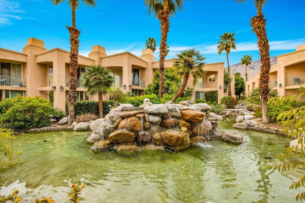 Welcome to DSCA, a serene and inviting au natural, gated community where lush landscapes, swaying palms, and a magnificent water fountain create a true desert oasis. This charming 2-bedroom, 2-bathroom retreat exudes warmth and comfort, featuring two cozy fireplaces perfect for cool desert evenings. Enjoy the convenience of an in-unit washer and dryer. Custom California Closet system offers ample storage along with handsome finishes. Step outside to the soothing sounds of the tranquil fountain from not one, but two private patios--ideal for morning coffee, al fresco dining, or simply unwinding in the fresh desert air. Indulge in the resort-style saltwater pool and spa, or fire up the grill in the dedicated BBQ area for outdoor gatherings with friends and family. Nestled near the heart of Palm Springs, you're just moments from world-class dining, shopping, golf, and endless outdoor adventures. Experience the magic of desert living in this exclusive oasis--