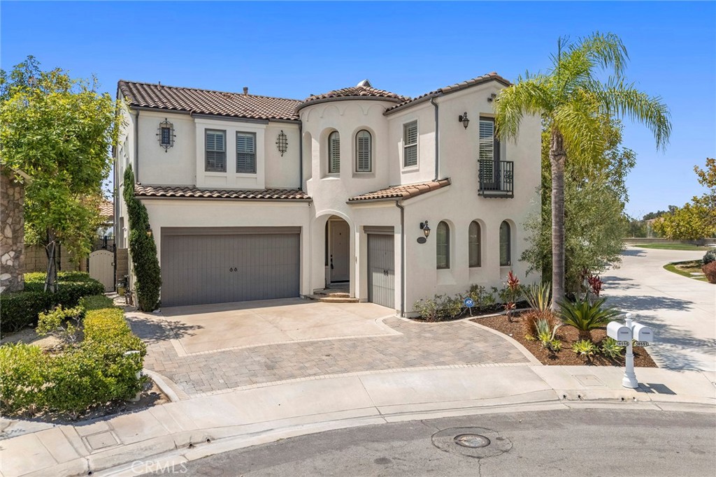 Tucked within a quiet cul-de-sac in one of Yorba Linda’s most sought-after communities, this former model home in the Foxfield enclave of Vista Del Verde offers the perfect balance of elegance, comfort, and resort-style living. With approximately 3,780 square feet of beautifully designed space, this home welcomes you with manicured landscaping and undeniable curb appeal. Step inside to a light-filled open floor plan, featuring rich wood flooring, neutral tones, and refined architectural details throughout. The formal living and dining areas are ideal for entertaining, while a desirable main-level bedroom with full bath provides a comfortable space for guests or multigenerational living. The chef’s kitchen is equipped with stainless steel appliances, abundant cabinetry, and a spacious center island, flowing seamlessly into the casual dining nook and family room—where large windows capture views of the spectacular backyard. Step outside into your private outdoor California room, complete with a built-in BBQ and cozy fireplace, perfect for year-round gatherings and relaxing evenings. The resort-style backyard continues with a sparkling pool featuring waterfall elements, a sport court, a children’s play area, an abundance of mature fruit trees, and 180-degree panoramic views, including nightly Disneyland fireworks and Catalina Island on clear days. Upstairs, a versatile office nook and an oversized laundry room with utility sink add functional space. The primary suite is a true retreat, with a private balcony offering sweeping west-facing views of Disneyland and Catalina. The en-suite bath includes dual vanities, a soaking tub, a walk-in shower, and a large walk-in closet—thoughtfully positioned to also take in the views. Two additional en-suite bedrooms complete the upper level. Additional highlights include: 2-car garage with single EV charger, ceiling storage, and built-ins. Located on a cul-de-sac near top-rated schools, parks, shopping, dining, and the prestigious Black Gold Golf Club! Love to entertain? Looking for show-stopping views and a resort lifestyle at home? This one checks every box.