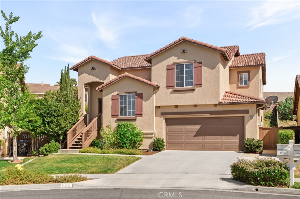 Nestled on a peaceful cul-de-sac, this lovely two-story home welcomes you with lush curb appeal and a warm, inviting presence. Inside, you’ll find a versatile formal living room or den upon entry—perfect for a home office or cozy retreat. Upstairs, the spacious family room features a charming fireplace and flows seamlessly into the dining area and open-concept kitchen, ideal for entertaining or everyday living. Step out onto the balcony off the dining area for fresh air and mountain views. Downstairs offers an additional expansive family room with direct walk-out access to the beautifully landscaped backyard. The private patio is surrounded by vibrant greenery, with a built-in BBQ and large water fountain creating a serene outdoor escape. A perfect blend of space, comfort, and indoor-outdoor living.
In addition, the owners pay the HOA fee, Solar and gardening service.