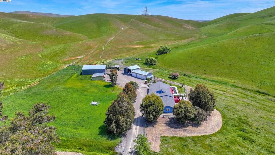 Tucked away in the rolling hills of Livermore, just 12 minutes from the charm of downtown and only 5 minutes from everyday conveniences like Costco, lies a rare opportunity to own your very own slice of country paradise. This one-of-a-kind 3 bedroom, 2 bathroom home sits on 35 acres with 12 flat, fully usable acres, ready to bring your dreams to life. Whether you’re envisioning a peaceful homestead, a family compound, or room to roam with your horses and animals, this property has the space and the setup to make it happen. Step inside the home and you’ll immediately notice the fresh updates, new stucco, crisp paint, updated plumbing, and modern LED lighting throughout, designed for both comfort and style. Multiple outbuildings are already in place and powered, offering endless flexibility for work, storage, hobbies, or guest quarters. There’s even a car lift included, perfect for any auto enthusiast. Outdoors, the land truly shines. The private well pumps 20 gallons per minute of some of the cleanest water in the canyon, ideal for creating a thriving garden, starting a vineyard, or supporting livestock. And with existing cattle stalls, horse potential, and open skies, your rural dream is closer than you think. This isn’t just a home, it’s a lifestyle, full of possibility!