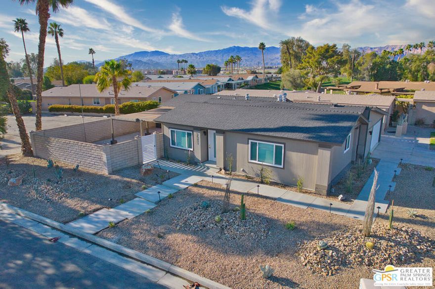 Located on a large corner lot. This completely renovated 2bed, 2bath manufactured home is both beautiful and exceptional! (There is not a surface that has not been updated) Featuring an open concept living room, dining room and kitchen. This home has been done in neutral colors with all new stainless steel appliances (including a refrigerator) , an extra long waterfall quartz kitchen island, farmer's sink  and soft closing cupboards & drawers galore. In addition to the central AC unit with a nest thermostat, there are 3 splits in the home (2 in the main living area and one in the primary bedroom.) The primary shower is extra large & beautiful. Ceiling fans in both bedrooms. LVP (luxury vinyl flooring) throughout. Laundry room includes new cupboards and new Whirlpool washer & dryer. Enter through an attached 2 car garage with additional room for a golf cart. The private covered patio (with 2 outdoor ceiling fans & lighting) and open concept area have mountain views. Landscaping is all new and low maintenance. Best of all, this home is within the Gated senior community of Ivey Ranch (where you OWN THE LAND!!) There's a 9 hole PGA rated golf course, driving range, tennis/pickleball courts, 4 community pools and 2 spas  (one pool & spa  just down the street, adult only usage). Enjoy social gatherings at the clubhouse and delicious meals at the restaurant "It's a Wrap".  Enjoy the desert lifestyle at its finest !! One special feature of this 55+ community, any other resident of home can be of any age under 55!!! unlike most 55+ communities that require all others at 45 or older. HOA includes basic cable, internet & trash. SELLER FINANCING AVAILABLE.