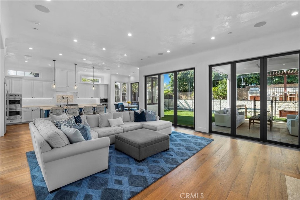 Rare East Manhattan Beach masterpiece where timeless elegance meets modern luxury. Built in 2021 by esteemed custom builder Patrick Kealy, on a coveted corner lot with a landscaped yard and white picket fence set the stage for timeless curb appeal. With 6 bedrooms, 6.5 bathrooms, a finished basement and approximately 5,738 SQFT (BTV) of living space on a 7,449 SQFT lot (BTV), this home offers scale without sacrificing warmth. Soaring ceilings and an open-concept floor plan flood the home with natural light and are enhanced by dramatic bi-folding doors that open seamlessly to a private backyard oasis—featuring a pool, spa, built-in Wolf BBQ and a custom Korean BBQ—creating the ultimate indoor-outdoor California lifestyle. The heart of the home is a chef’s kitchen featuring top-of-the-line amenities with exquisite finishes, a walk-in pantry, stainless steel Viking appliances including double ovens, a bonus warming drawer, and a Wolf built-in espresso maker. The lower level offers a full basement with a full bar equipped with ice maker, refrigerator, and dishwasher perfect for a media room, playroom or a gym, complete with a guest suite. The upper level finds the majority of the bedroom suites, each with its own en-suite bathroom vaulted ceilings, and custom closets. The primary suite is like a retreat with a romantic fireplace and spa like primary bath. Located in one of Manhattan Beach’s most desirable neighborhoods, East Manhattan Beach offers larger lots, larger homes, and close proximity to award-winning schools and parks. This residence is the Complete Family Retreat – a home that gives kids space to play, parents space to entertain, and everyone space to unwind. Only 15 minutes to LAX