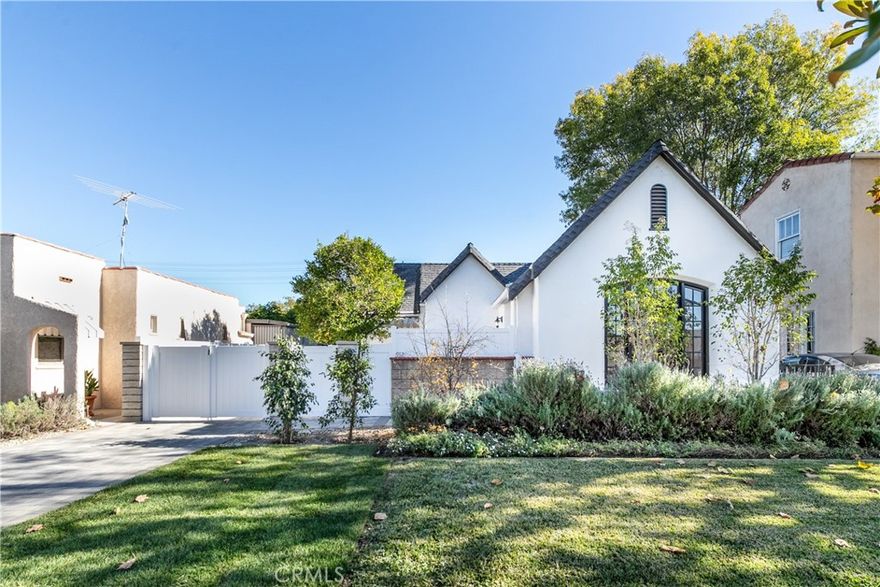 Enjoy life on the grounds of this beautiful residence with lush landscaping and stunning curb appeal. The charming interior has 2 bedrooms, 1-1/2 bathrooms and 1,295 square feet of living area. Enjoy complete privacy, gorgeous wood like floors, a sleek and modern fireplace, beautiful windows that bathe the rooms with sunshine. The updated kitchen has counterspace galore, plentiful white shaker cabinets, a pantry closet, water filter near the sink, and beautiful backsplash. The primary bathroom has double sinks.  Enjoy the convenience of your indoor full-sized washer and dryer with adjoining storage cabinets.  Enjoy the benefits from a water softener, linen closet, and an insulated garage that could potentially be used as an office with mini split AC & Heat and closet. Beautiful paver driveway leading to a spacious backyard with large grassy area with fruit trees and expansive patio space.