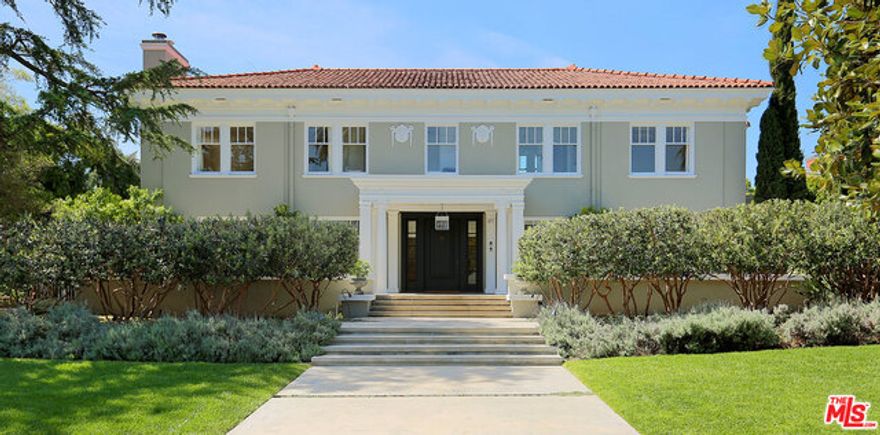 Exquisite Windsor Square Estate w/ newly remodeled guest cottage, large pool, & beautifully landscaped grounds. Built in 1914, this Mediterranean Revival, designed by Morgan Walls & Morgan, is exquisitely updated while maintaining the original details. Discretely shielded behind a lush pineapple-guava grove, the formal entry opens to a dramatic gallery-foyer & grand stairwell. The light & spacious formal living room w/ FP & dining room are designed for contemporary entertaining, as are the music/library & media rooms. The gourmet chef's kitchen opens to a large breakfast room & professional pantry. The main house includes 2 en suite masters that open to one another if desired. 2 to 3 additional bedrooms upstairs including a 1-bedroom guest suite w/ living room (or tandem 2 bedroom suite). Impeccably remodeled attic/play room & bath on 3rd floor. 4 or 5 bedroom, 7 bath main house w/ 6,729 sf. & 772 sf. guest cottage & cabana; both w/full baths. 2 car garage. Close to Larchmont Village