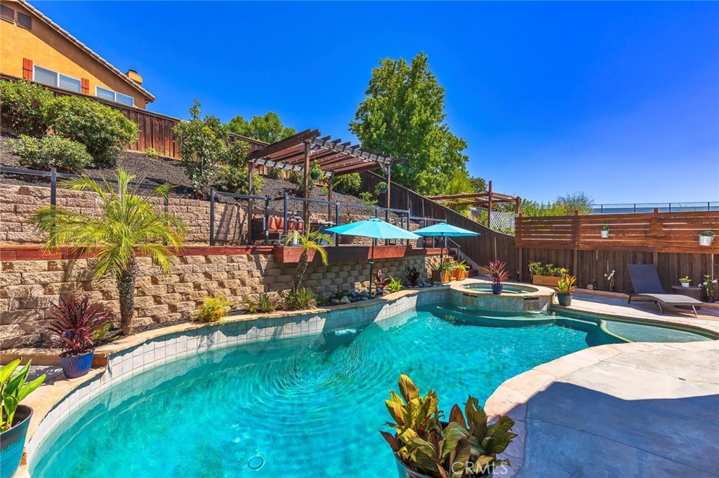 This is the one you've been waiting for! SINGLE STORY POOL HOME in the HEART of Temecula! This lovely family home has been completely remodeled with a bright white kitchen, large shiplap island for entertaining, barn door pantry, wood beams, Roman shade, wine fridge, stainless steel appliances with farm sink, Italian stone backsplash, pot filler and sleek black quartz countertops. Enjoy the tranquility of a formal living and dining room that offers some separation for those cherished Holiday family dinners or quiet conversations away from the crowd. Open concept Family Room/ Dining area is open to the adjacent kitchen where everyone gathers. Step outside into your entertainers backyard with lagoon style POOL AND SPA and unique upper deck that overlooks the pool area. Set up your projector and watch movies under the stars in the privacy of your own oasis! 4 bedrooms and 2 completely updated bathrooms! Secondary bathroom has been upgraded to a beautiful neutral color scheme with glass subway tile backsplash, subway tiled tub/shower, new paint, new bathtub, new toilet, new vanity, new mirrors, new lighting, new flooring and new fixtures. Primary suite is generous in size and has a spa like bathroom with modern yet neutral decor, elegant Italian marble tiled tub and shower area, floating soaker tub, long floating black vanity with gold accents, new mirrors, lighting, flooring, toilets and paint. Be the first to bathe in this luxurious bathroom after a relaxing day sitting pool side. This beautiful home is carefully thought out with 10 foot ceilings, arched doorways and 8 foot doors. Chantemar way has a wonderful layout that also offers privacy between neighbors in a great location while also providing easy access to the freeways for commuters. Take in a pre-dinner stroll over to the park and then to your favorite restaurant without even starting your car! Convenience at its finest! All with LOW TAXES, No HOA, Affordable Solar and commuter friendly! Make sure you put this home on your list, you don't want too miss it! Get on the schedule now!