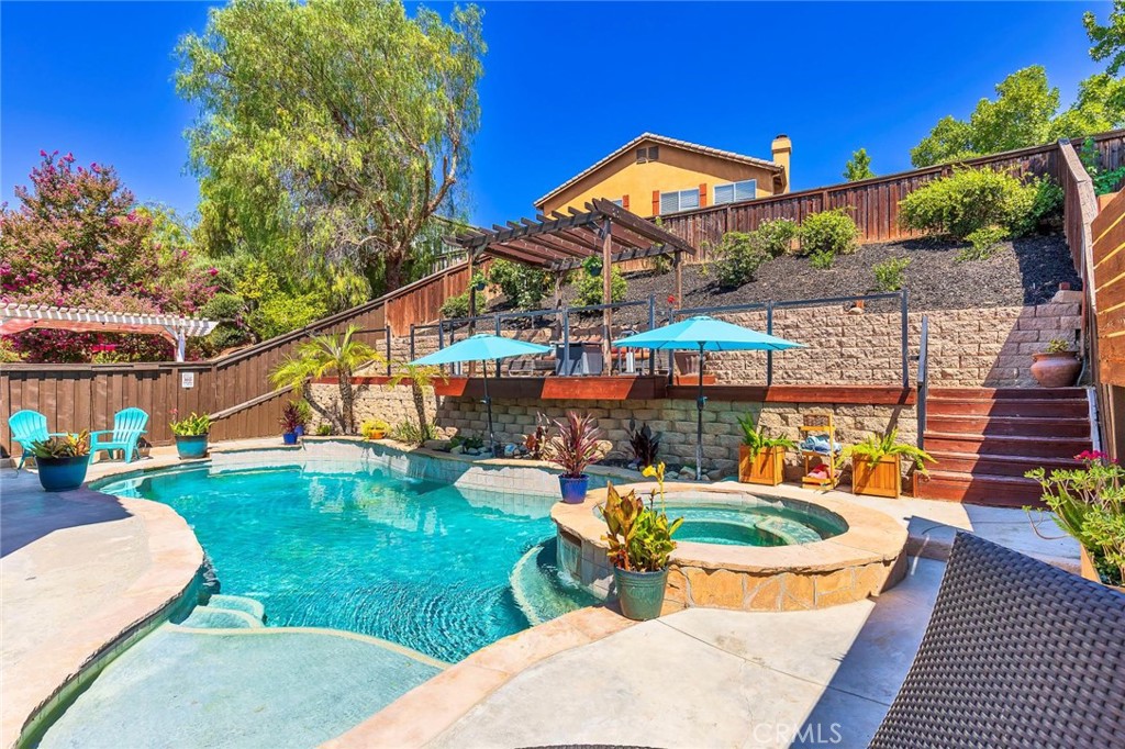 SINGLE STORY POOL HOME in the HEART of Temecula! This is the one you've been waiting for! This lovely home has been completely remodeled with a bright white kitchen, large shiplap island for entertaining, barn door pantry, custom wood beams, Roman shade, wine fridge, Stainless steel hood, stainless steel appliances and farm sink, Italian stacked stone backsplash, pot filler and sleek black quartz countertops. Enjoy the tranquility of a formal living and dining room that offers some separation for those cherished Holiday family dinners or quiet conversations away from the crowd. Open concept Family Room/ Dining area is open to the adjacent kitchen where everyone gathers. Step outside into your entertainers backyard with lagoon style POOL AND SPA and unique upper deck that overlooks the pool area. Set up your projector and watch movies under the stars in the privacy of your own oasis! 4 bedrooms and 2 completely remodeled bathrooms! Secondary bathroom has been upgraded to a beautiful neutral color scheme with glass subway tile backsplash, subway tiled tub/shower, new paint, new bathtub, new toilet, new vanity, new mirrors, new lighting, new flooring and new fixtures. Primary suite is generous in size and has a SEXY SPA-like bathroom with modern yet neutral decor, elegant Italian marble tiled tub and shower area, floating soaker tub, large floating black vanity with gold accents, mirrors, lighting, new flooring, new toilet and fresh paint. Be the first to bathe in this luxurious bathroom after a relaxing day sitting pool side. This beautiful home is carefully crafted with 10 foot ceilings, arched doorways and 8 foot doors. Chantemar Way has a wonderful layout that also offers privacy between neighbors in a great location while providing easy access to the freeways for commuters. Rarely ever the need for AC! This home is energy efficient and maintains temperatures even when outside temps are into the 90's. But just in case you do need AC, have comfort in knowing you are Saving $$$ with your energy producing solar panels. Take over low $200 payments and never pay an electric bill. Take in a pre-dinner stroll over to the park and then to your favorite restaurant without even starting your car! Convenience at its finest! All with LOW TAXES, No HOA, Affordable Solar and commuter friendly! Make sure you put this home on your list, you don't want too miss it! Get on the schedule now! Sellers are also gifting you 6 months of FREE POOL SERVICE and a Filter Cleaning.