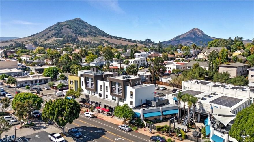 Modern Downtown Condo in the Heart of San Luis Obispo
Experience contemporary living in this stylish 2-bedroom, 2-bath condo with a spacious upstairs loft/possible 3rd bedroom—designed with the feel of a luxury hotel. The sleek kitchen features modern cabinetry, granite countertops, and stainless-steel appliances, seamlessly flowing into the open-concept living area. An industrial roll-up door connects the interior to the outdoors, filling the space with natural light and downtown energy.
Both bedrooms and one bath are conveniently located on the main level, while the loft opens to a private rooftop deck with sweeping views of downtown San Luis Obispo and the surrounding mountains. Eco-friendly elements—such as passive heating and cooling, south-facing windows, and cool-roof technology—complement the home’s sophisticated modern design.
Located on the third floor with elevator access, this condo offers an effortless urban lifestyle—steps from shopping, dining, and entertainment, within a mile of Cal Poly, and with easy freeway access.