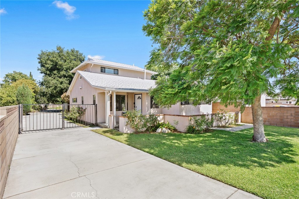 This charming two-story single-family home is located on a quiet street in Temple City, blending timeless mid-century character with thoughtful modern updates. The landscaped front yard, cozy patio, and gated extended driveway, ideal for multiple cars or RV.
Offering 3 bedrooms plus a den (optional 4th bedroom), 3 bathrooms, the home includes a living room, family room, dining area, kitchen, and laundry area. Upgrades include new carpet, laminate wood flooring, recessed lighting, central A/C, ceiling fans, and remodeled bathrooms, making it move-in ready.
The inviting living room highlights an oversized bay window that fills the space with natural light. The upgraded kitchen features white shaker cabinets, quartz countertops, gas range, hood, built-in microwave, and laminate flooring. A cozy dining area and laundry with stackable washer/dryer add everyday convenience. The family room offers a brick fireplace and sliding doors to the backyard for seamless indoor-outdoor living.
Two bedrooms and two baths on the main level provide privacy for multigenerational living. Upstairs are two additional bedrooms and a full bath, with one currently used as an office, offering flexibility for today’s lifestyle needs.
The expansive L-shaped backyard offers mature trees, wide lawn, fruit trees, a detached 2-car garage, and covered carport. The deep lot provides endless options—whether you envision an ADU, home addition, pool, this property delivers with exciting future potential.