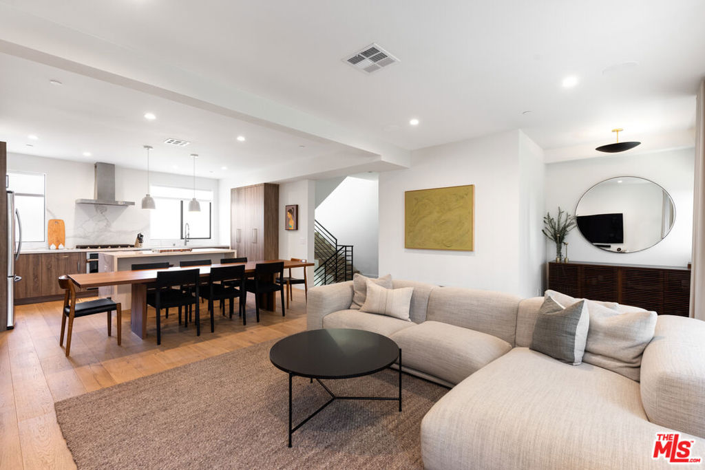 Presenting this spectacular new designer home with private rooftop! Sleek, Sophisticated, and Set in the Heart of Hollywood. Discover this stunning new 3BR/3.5BA modern retreat at Skye Lexington - a limited collection of designer residences defined by clean lines, dramatic scale, and refined finishes. This chic home is appointed with white oak floors, Italian porcelain tile, terrazzo bath flooring, and a chef's kitchen with smart appliances and a striking waterfall-edge island. The sun-drenched open layout is perfect for entertaining, while the luxurious primary suite features a spa-style, newly tiled bath and walk-in closet. Enjoy unforgettable al fresco moments under the stars on your private rooftop deck with sweeping 360 views. A perfect fusion of architectural elegance and effortless livability in one of LA's most walkable neighborhoods.