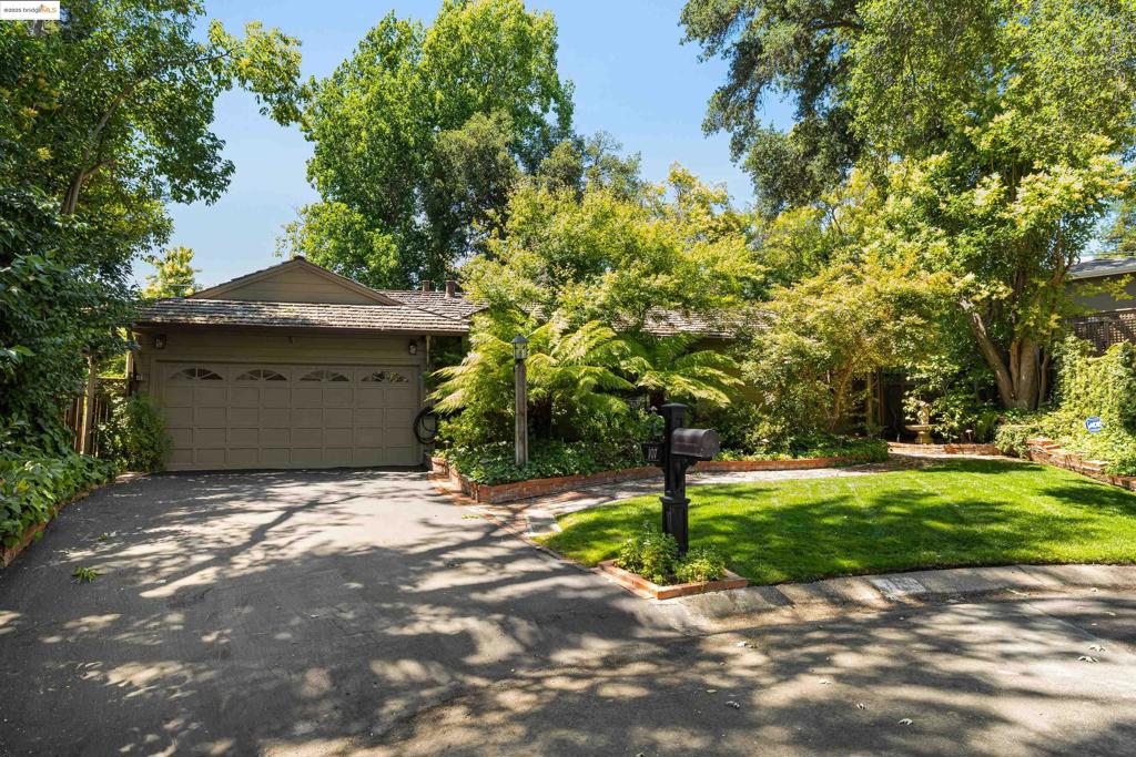 Nestled in the heart of Pleasant Hill’s coveted Poet’s Corner, this charming circa 1948 home offers 3 bedrooms, 2 bathrooms, and approx. 1,829 sq.ft. of living space on a lush 8,900 sq.ft. lot (per public records). Tucked at the end of a serene cul-de-sac, the property boasts a verdant, park-like setting anchored by a majestic Oak tree and surrounded by vibrant gardens, patios, and wraparound decking. Inside, you'll find beautiful oak hardwood floors, a formal living room with fireplace and garden access, and a spacious open kitchen/family room with exposed brick, wood-beamed ceilings, fireplace, and a wall of windows overlooking the backyard oasis. The remodeled main bath features marble finishes, and the expansive primary suite offers a custom en-suite and direct access to the rear garden. Additional features include solar power, A/C, and a garage with built-in cabinetry and interior access. Close to parks, BART, shops, and restaurants—this is truly a special place to call home.