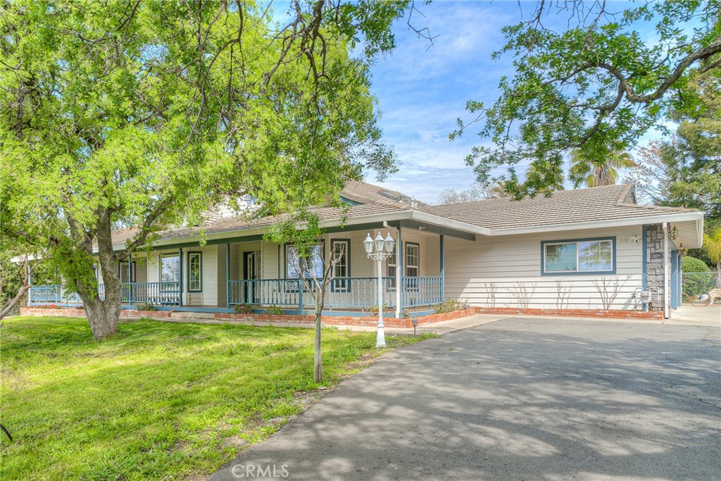 COUNTRY COMFORT, CITY LOCATION. This beautiful, custom home will check all the boxes on your wish list. This Single Level, 3 bedroom, 2 ½ bath home is perfect for summer entertaining. The in-ground pool is surrounded by beautiful landscaping, with a covered patio, all easily accessed from the Kitchen and Great Room. The 2-acre yard is fenced and cross-fenced, with lots of parking for your guests, even an RV carport with electrical hook-up. This is one of Oroville's prime neighborhoods, conveniently located near downtown, and just minutes from Lake Oroville with all its hiking, biking, and horse trails. You'll enjoy the Beautiful Views from the covered front porch which extends the full length of the house, offering room to sit and relax. Features include Owned Solar, separate HVAC systems for the living area and bedrooms, a 3-Car garage with a work bench, a 3-stall barn for storage or hobbies, a Cement Tile Roof and best of all, a Dream Kitchen. The Granite-topped center island has a 6-burner, Natural Gas Cooktop and seating for 4. All appliances are stainless steel, with Double electric ovens, built-in Microwave, and an abundance of cupboard and pantry space. Skylights and recessed lighting keep the kitchen cheery and bright. The kitchen flows seamlessly into the Family Room with its dining nook, vaulted ceilings, new engineered hardwood floors, a cozy wood stove, and a window wall opening onto the back patio, fenced yard and pool. For more formal occasions, there is a large dining room and a newly carpeted living room featuring French doors, a fireplace and a wall of bookcases. The Primary Suite is huge, with a Walk-in Closet and an en suite bath that includes a jetted tub, glass-walled shower, dual sinks, and new Luxury Vinyl Flooring. The other two bedrooms also have Walk-in Closets. The guest suite has an adjacent bathroom and direct access to the patio and swimming pool. The driveway is gated for added privacy and security and the home has an alarm system and security cameras. Make an appointment to see it before it's sold!