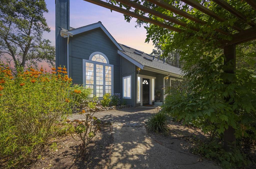 Discover your serene escape with this charming coastal farmhouse-inspired property, perfectly perched atop a hill secured by a gate for utmost privacy and stunning views. Nestled on a sprawling 3.45-acre lot, this home features 4 spacious bedrooms, an additional versatile office/bonus room, and ample room for family and guests. Step inside to find beautiful terra cotta tile floors that lead you through the open and airy living space with Vaulted beam ceilings. The industrial-style kitchen boasts quality finishes, making it a perfect spot for culinary enthusiasts to unleash their creativity. The master bedroom is conveniently located on the main floor, providing easy accessibility, while a generous bonus/bedroom with a closet offers flexibility for guests or additional living space. Upstairs, you'll find three well-appointed bedrooms, each filled with natural light and delightful charm. This property is a true haven for nature lovers, featuring well-established gardens and space for your equestrian dreams, small farm living, potential for a large workshop and Adu! This home provides the perfect combination of tranquility and convenience. Don't miss your chance to own this unique property in a picturesque setting!