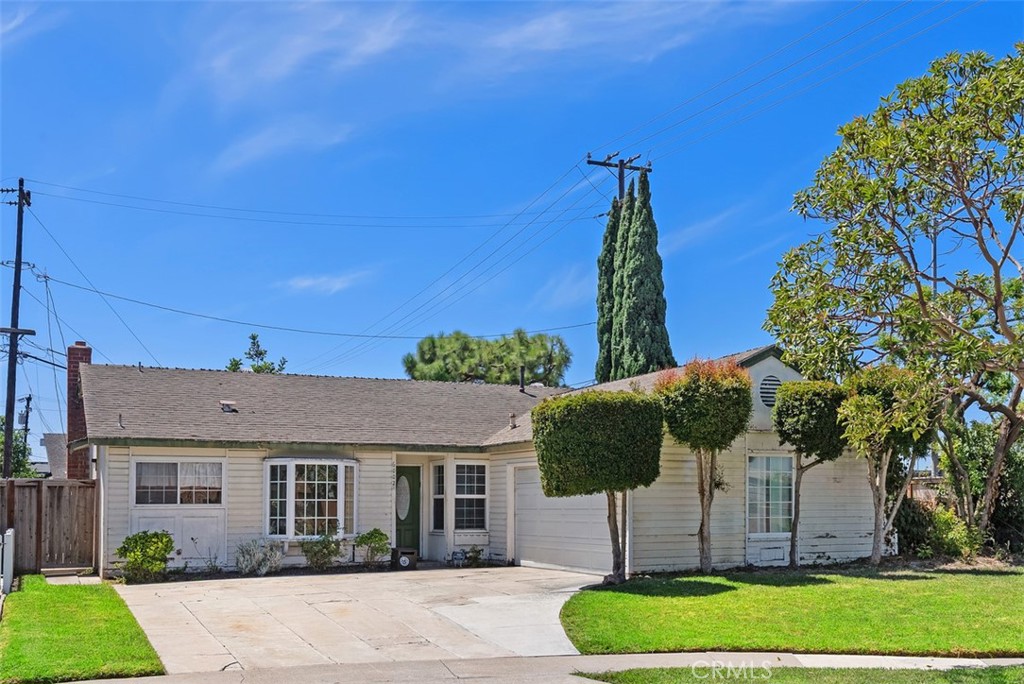 This lovely beach homes resides on an over sized lot at the end of a cul-de-sac with possible RV access. Once inside, you are greeted by a formal living room with a fireplace. There is a large dining area which flows into the kitchen. The kitchen features tile counter tops, a gas cook top and a large pantry. All of the bedrooms are carpeted and offer ceiling fans. The primary bedroom is quietly situated at the rear of the home and features a French slider leading to the rear yard. The hall bath features a bathtub/shower combo with tiled surround, tile countered vanity and tile flooring. The primary bathroom offers a shower and tile flooring. Bonus features include; tile flooring in the entry, kitchen and dining area, natural hardwood flooring in the living room and hallway, textured ceilings, crown molding, some dual pane windows & slider, a bay window and a newer heating and air conditioning system with all new ducting. The private rear yard features a large patio, a garden area as well as a large side yard which would make a great place to add a garden. Best of all, the home is walking distance to award winning schools, several parks, golf, shopping, restaurants and is only a 5 minute drive to the beach!