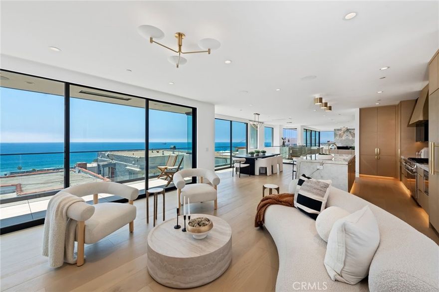 Introducing an unparalleled coastal masterpiece where modern elegance meets breathtaking ocean and whitewater vistas that must be seen to be believed. Situated on a prime corner lot with 4322sf of living space, this newly constructed residence seamlessly blends indoor and outdoor living spaces for ultimate Southern California luxury. Almost all of the 84 ocean-facing feet of the upper level are framed by Fleetwood doors and windows which truly capture the stunning panoramic ocean views from Palos Verdes and Catalina Island all the way to Malibu. This is by far one of the finest homes built in Manhattan Beach! The gourmet kitchen, equipped with state-of-the-art appliances and white oak cabinetry, flows effortlessly into the spacious living and dining areas, making it perfect for both intimate gatherings and grand entertaining. The primary suite serves as a spa-like sanctuary, featuring a steam shower, Venetian plaster walls, two-sided fireplace, and a generous walk-in closet. Additional four junior suites are masterfully designed, each with en-suite bathrooms and ample closet space. The expansive decks provide a serene setting for sunset views over the ocean, while the outdoor living area on the walkstreet offers ultimate relaxation and entertainment. Situated just steps from the beach, this property provides convenient access to upscale dining, boutique shopping, and top-rated schools. The corner location of this home allows for the key advantages of capturing up to 2 extra feet of width for the home, much more natural light, and much better views. 
Additional features include: 
-Meticulous attention to detail and highest quality finishes throughout 
-Two gorgeous wet bars with beverage centers and ice makers 
-A custom 200-bottle conditioned wine showcase 
-Lutron lighting 
-Smart home ready 
-Dolby Atmos Ready in 3 viewing areas 
-Electric heated floors in all full bathrooms 
-European oak floors 
-TWO laundry rooms 
-A luxurious stained oak elevator 
-Extra-spacious 3 car garage 
-Infratech heaters 
-4 stunning fireplaces, including a hand-plastered artisanal fluted fireplace 
-Flush door sills for a seamless indoor/outdoor experience 
-9 separate climate control zones 
-Utility undergrounding district is in process. 
With mesmerizing ocean and whitewater views, elevated design, and a location that captures the best of the South Bay lifestyle, this unbelievable home and view must be experienced in person to be fully appreciated.