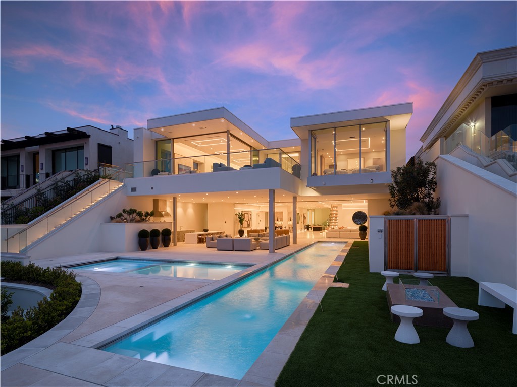 1119 Dolphin Terrace, a generational trophy property designed by Christopher Brandon showcases exceptional modern design and architectural excellence located in the heart of Corona Del Mar's coveted Irvine Terrace community. This meticulously crafted estate, taking six years to reach completion, spans approximately 10,200 sqft of pure luxury on a uniquely deep and expansive lot. This remarkable property boasts 5 bedrooms, including 2 primary bedrooms, and 8 baths, offering unparalleled comfort and sophistication. The interiors feature massive scale and soaring ceiling heights, creating a sense of grandeur that defines Southern California coastal living at its finest. Entertain with ease in the expansive living spaces, highlighted by a media wall with a jaw-dropping 219" LCD TV wall, a well-equipped bar + glass cellar, and two kitchens for culinary enthusiasts. Motorized pocket doors seamlessly blend indoor and outdoor living, leading to a spectacular 65' lap pool that invites you to relax and unwind while enjoying breathtaking ocean, jetty, Balboa, and coastline views. For those who prioritize health and wellness, the property includes a spacious wellness center offering full-size gym, sauna, steam room, and meditation area, ensuring a holistic approach to your total well-being. The attention to detail is evident throughout, making this estate one of the most captivating and exciting properties to ever be publicly offered for sale in Corona Del Mar. Additional features enhance the allure of 1119 Dolphin Terrace, such as its proximity to the Newport Beach Country Club and Fashion Island, placing world-class amenities at your doorstep. Enjoy the convenience of walking to Balboa Island and relish the central location within Newport Beach, providing easy access to the best that Southern California has to offer. This is not just a residence; it's a lifestyle statement, a testament to luxury living in one of the most desirable locations on the West Coast. Seize the opportunity to own a landmark property that transcends the ordinary, a true embodiment of Southern California's finest. Welcome home to 1119 Dolphin Terrace, where every detail reflects a commitment to unparalleled quality and refinement.